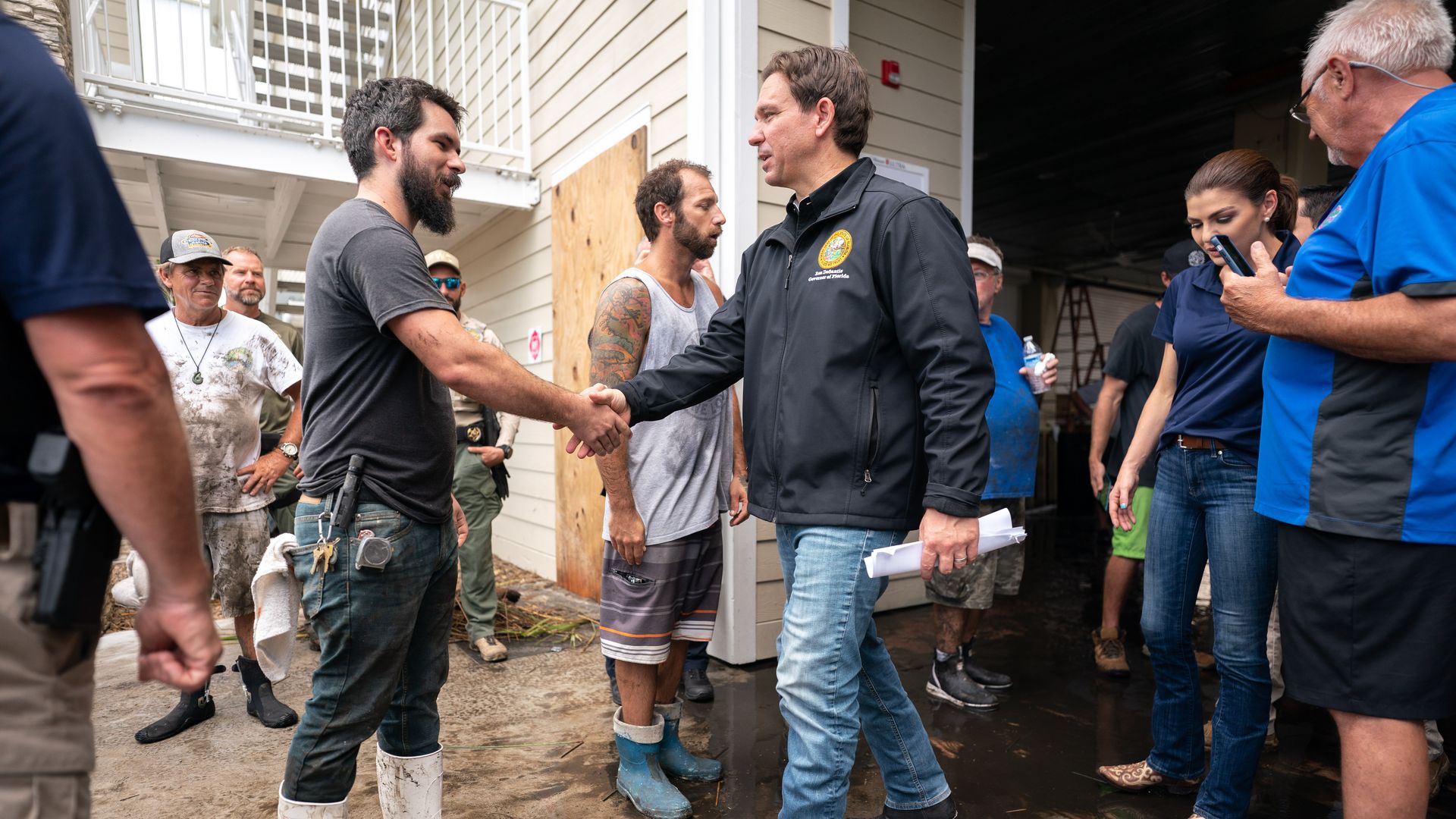 Florida Gov. Ron DeSantis, center, shakes hands following a press conference in the aftermath of Hurricane Idalia on August 31, 2023 in Steinhatchee, Florida. 