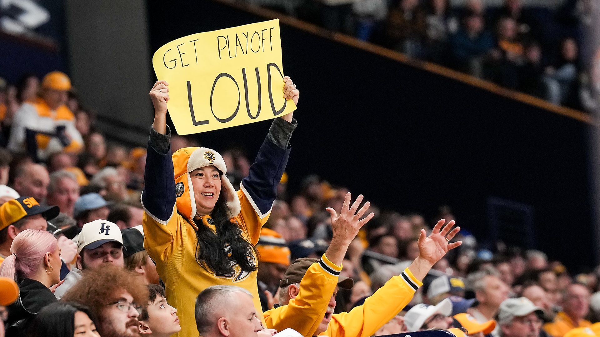 Nashville Predators fans cheer on their team during an NHL game against the St. Louis Blues.