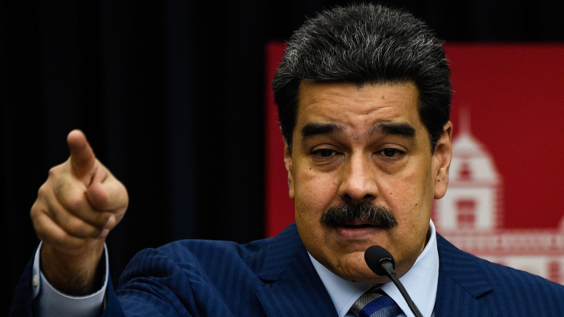 Nicolas Maduro speaking at a lectern