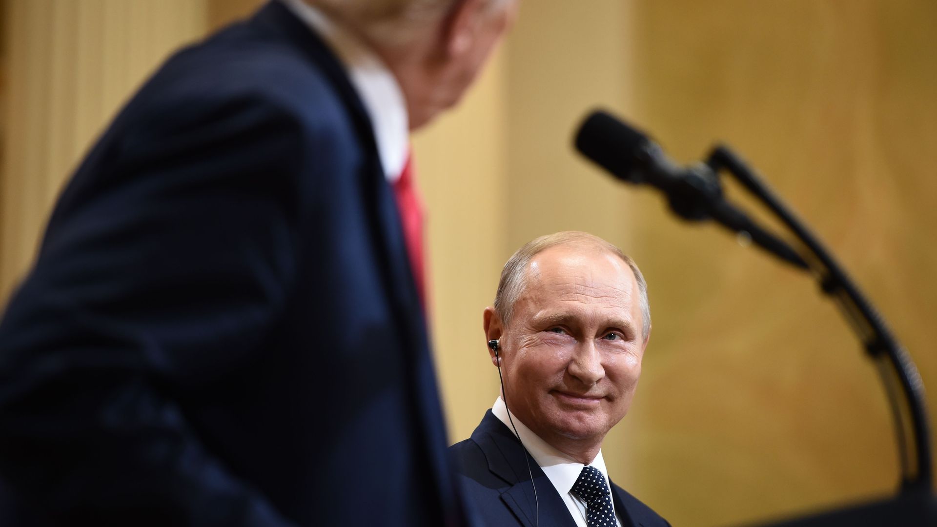 Vladimir Putin smiling at Donald Trump.