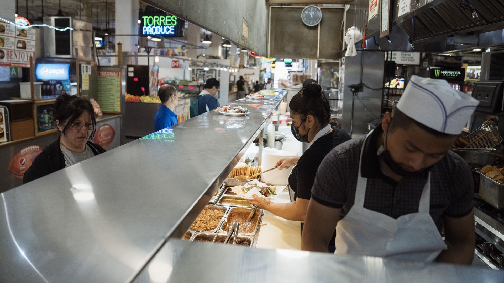 Workers and patrons at a restaurant at Grand Central Market in Los Angeles, California
