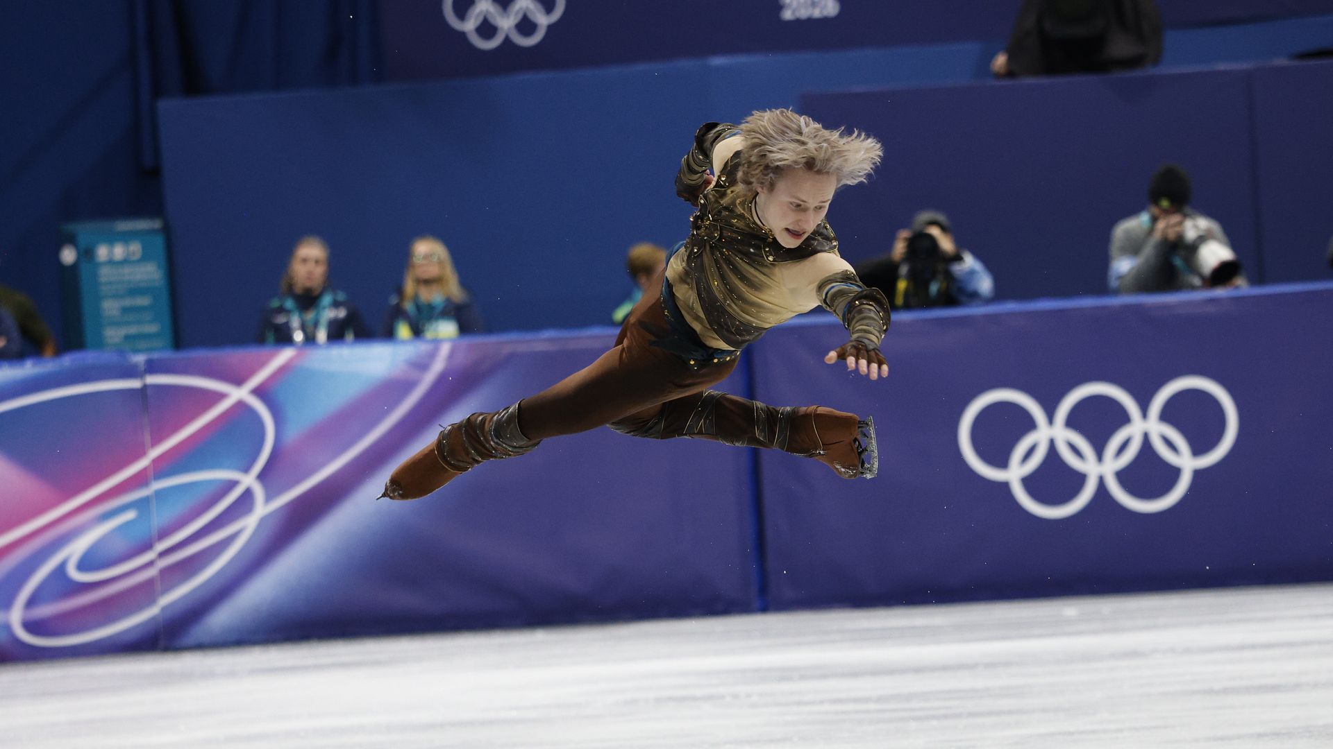 Ilia Malinin flying through the air during Saturday's team figure skating men's short program.