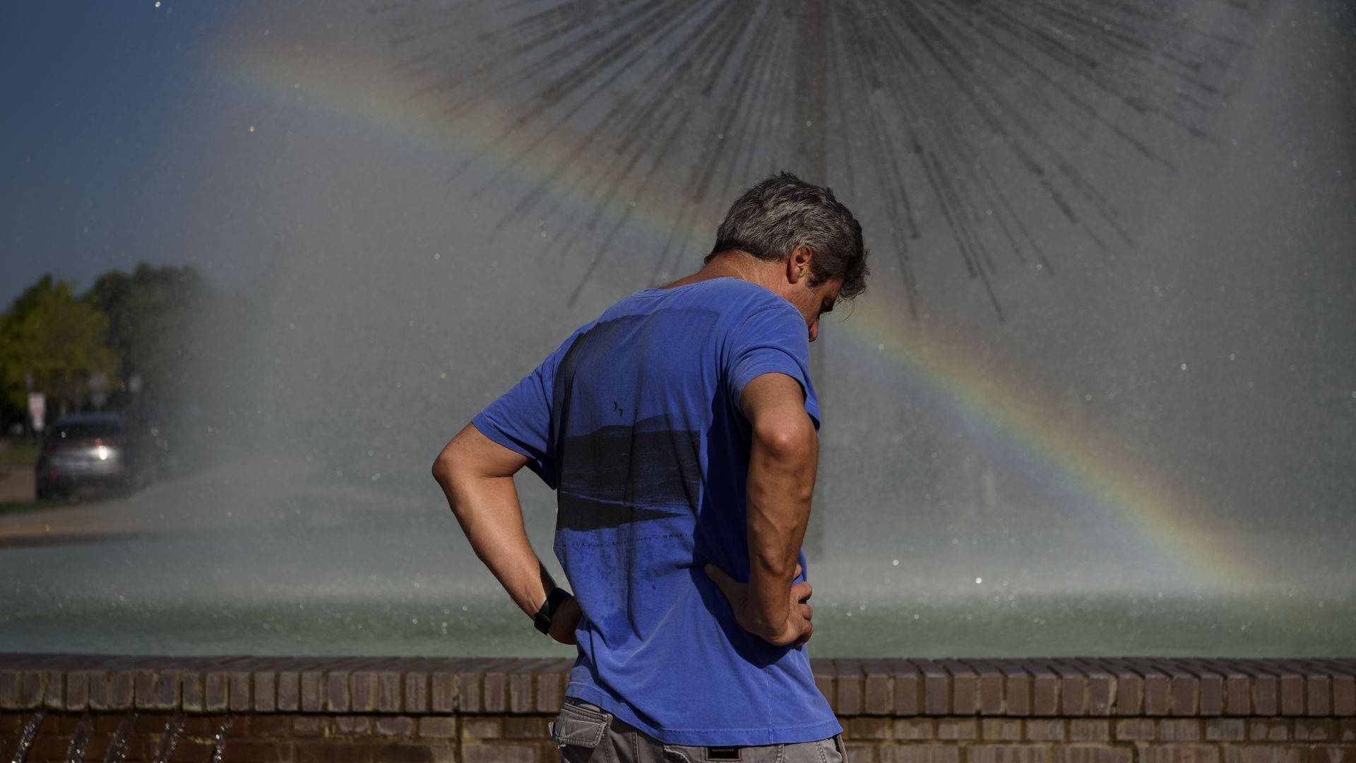 A person cools off near a fountain during a heatwave in Houston