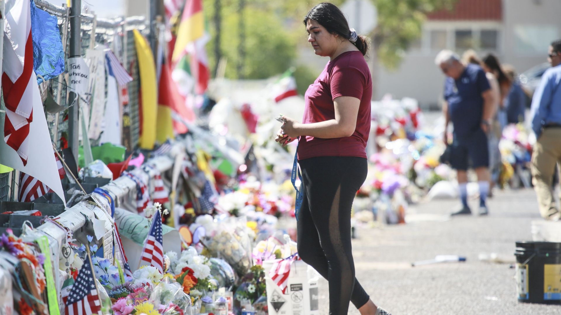 A woman paying her respects at a makeshift memorial for the victims in El Paso. Photo: Sandy Huffaker/Getty Images
