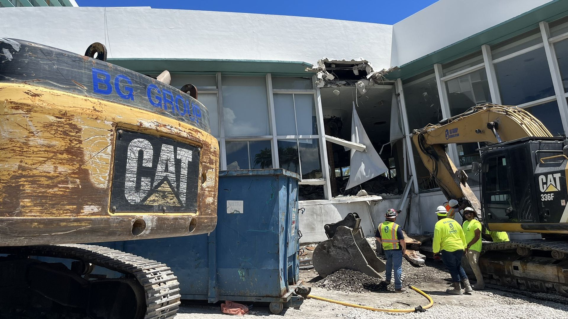 Bulldozers sit at a construction site where a building is being demolished.