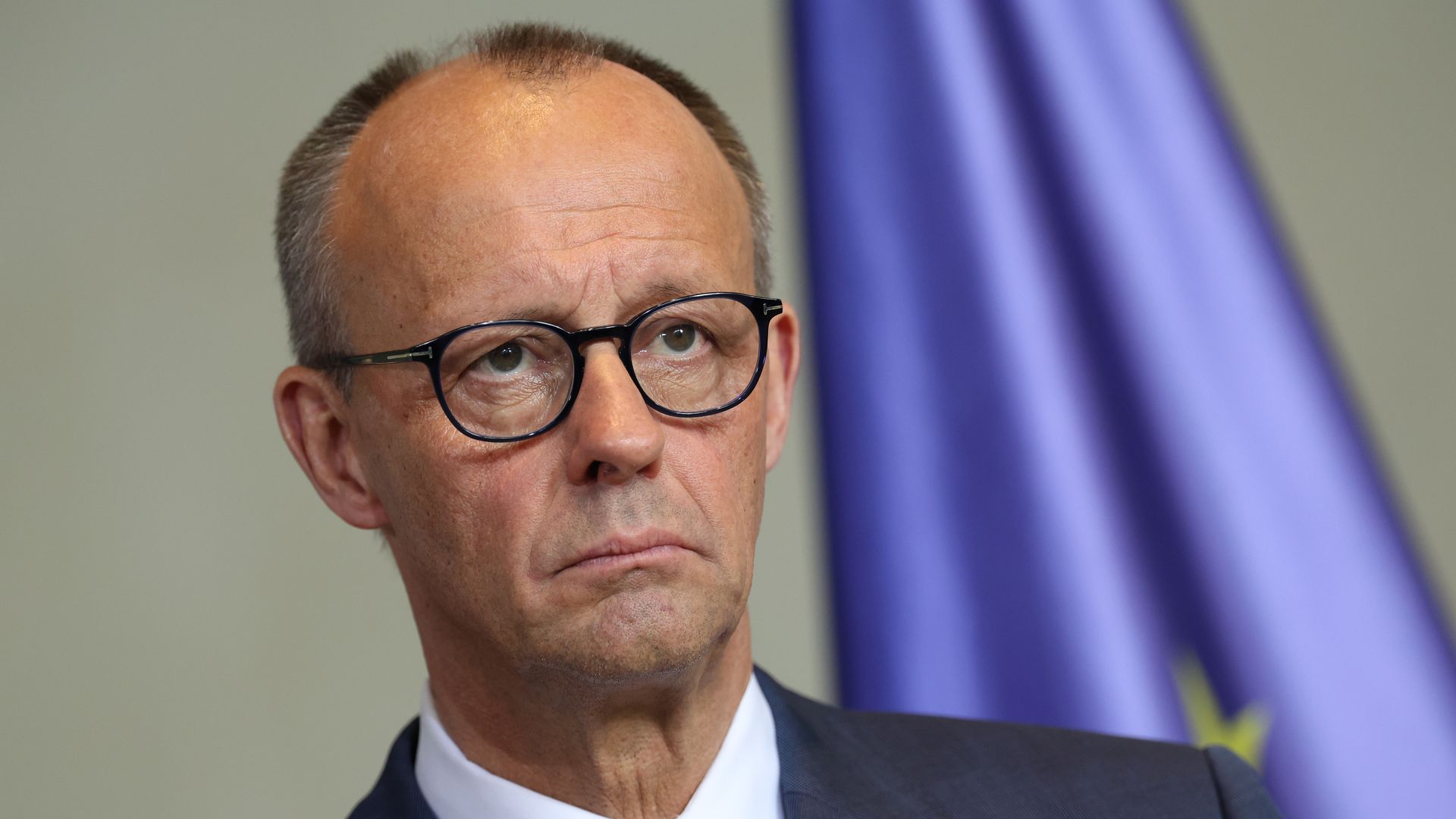 German Chancellor Friedrich Merz looks on during a press conference.