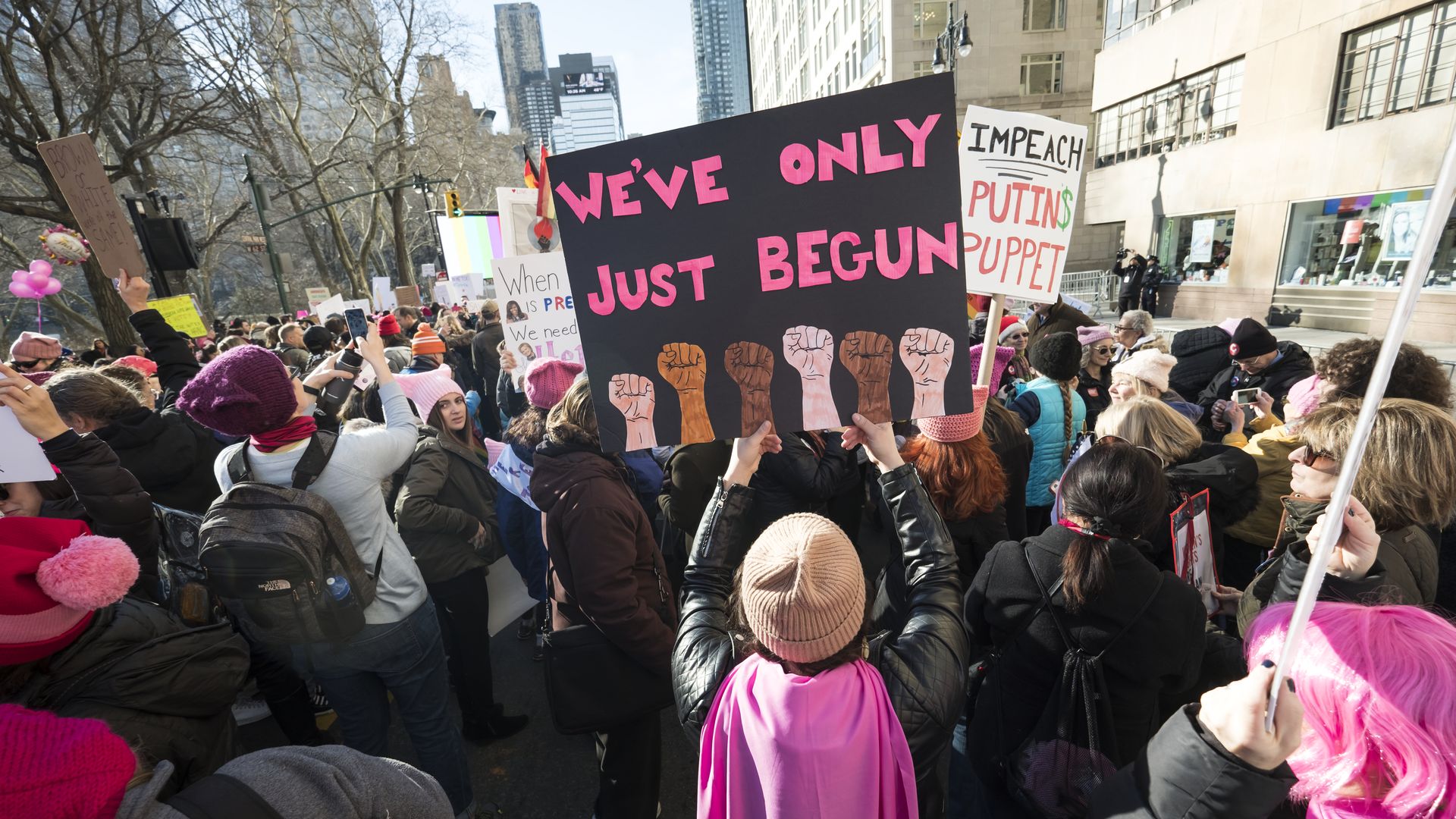 Women's March 2018; A protestor holds a sign that reads, "We've only just begun." 