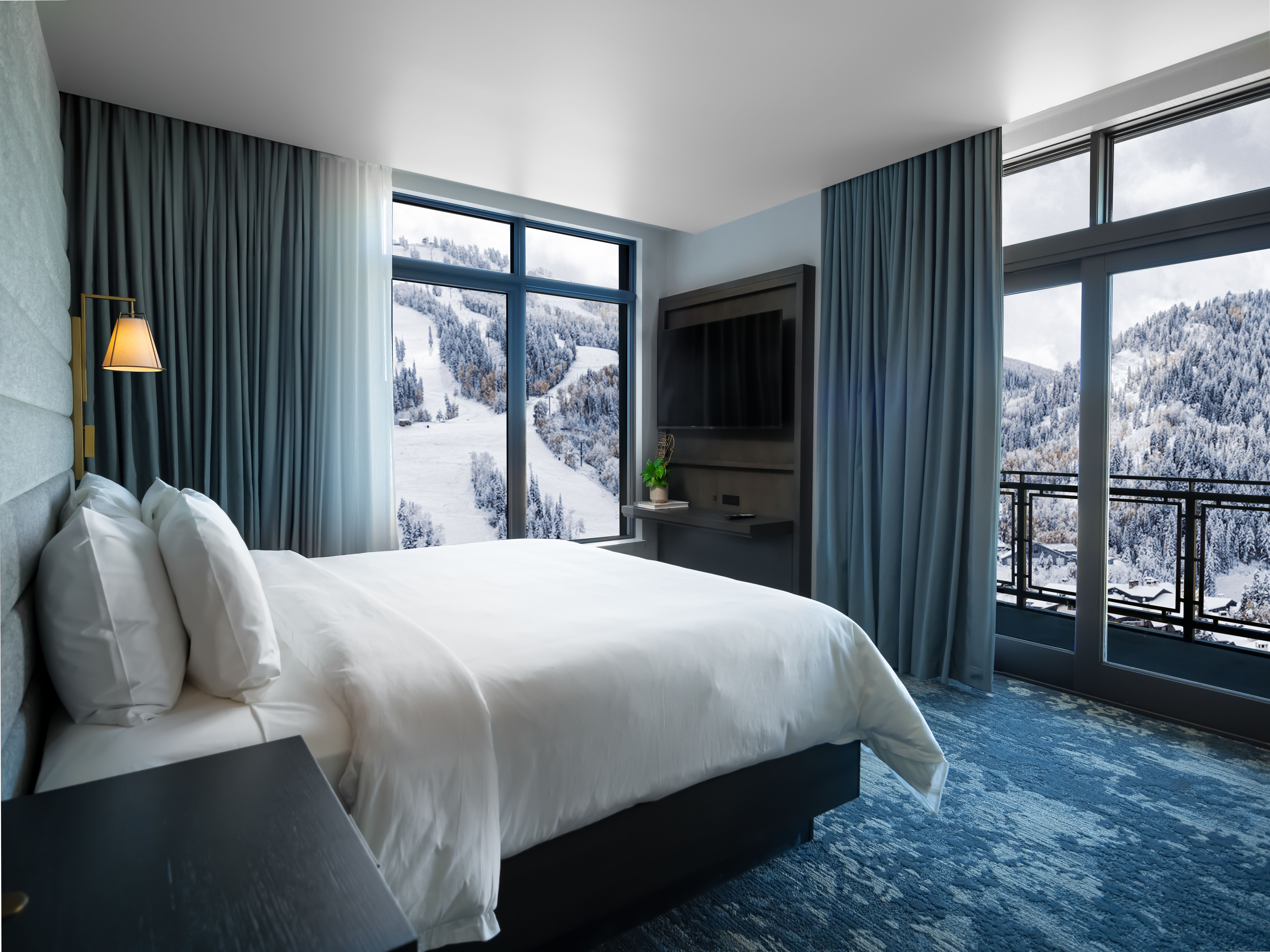 A hotel room featuring views of snowy mountains. 