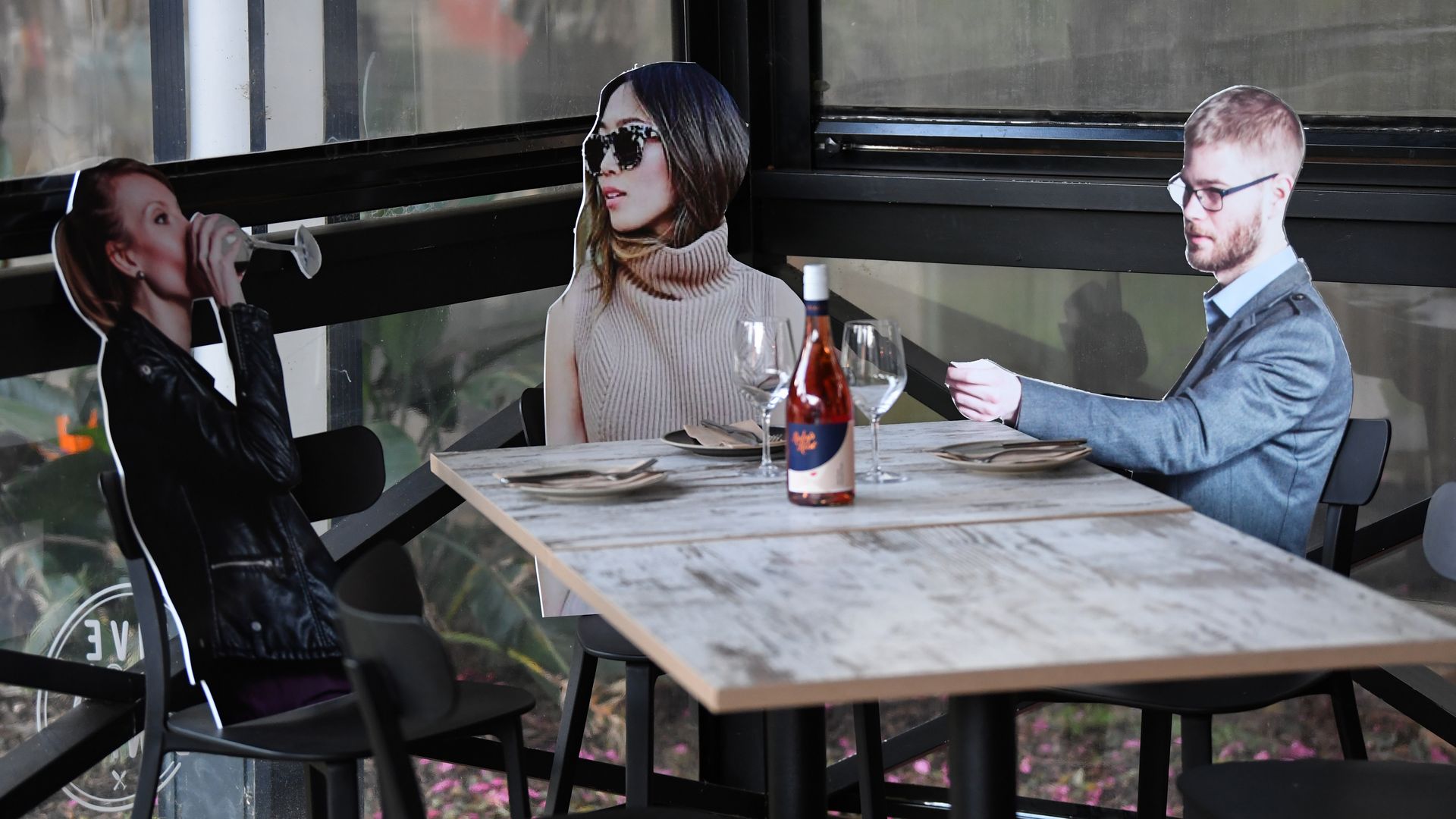 Cardboard cutouts of diners sitting at a restaurant