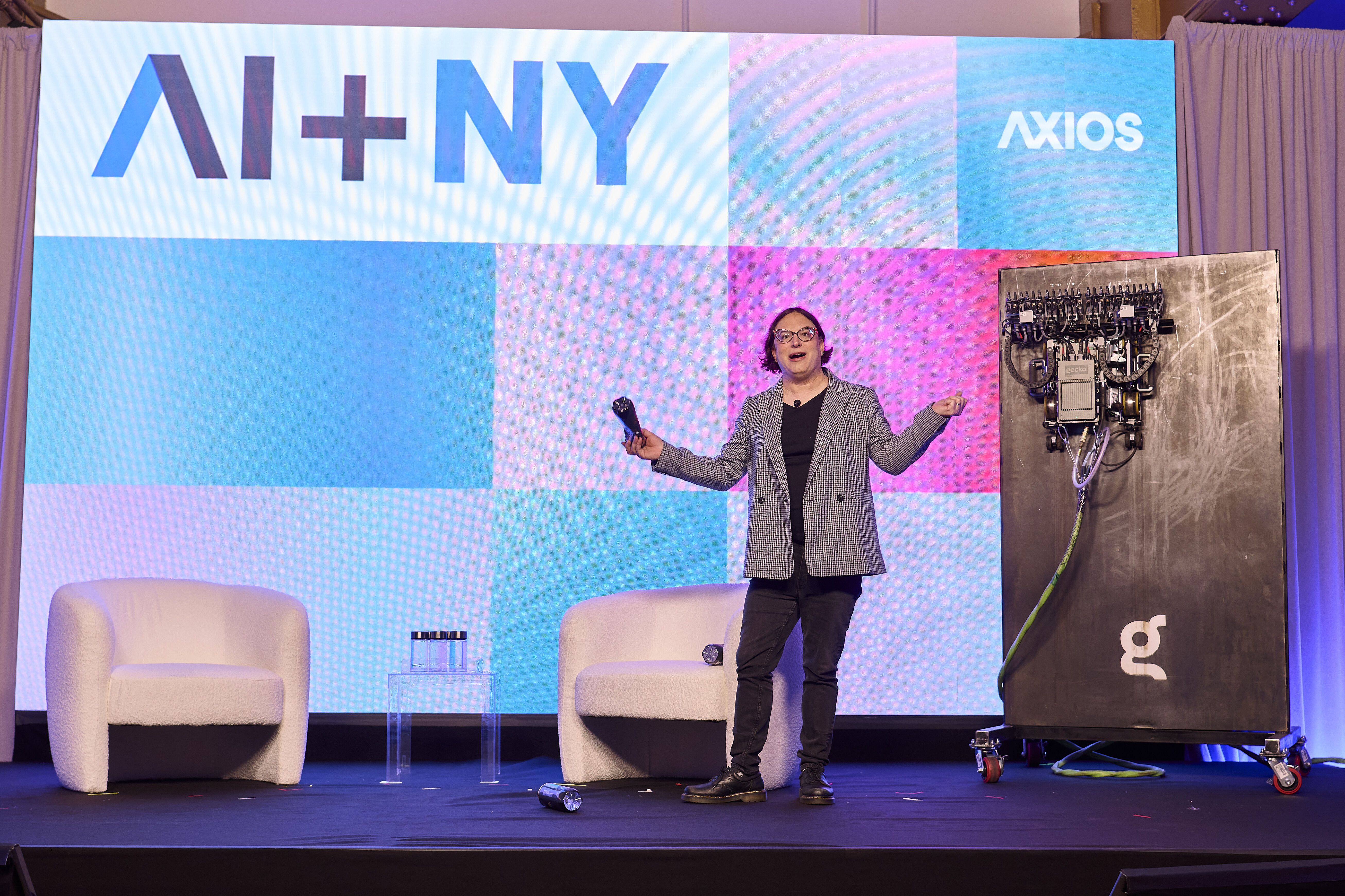 Axios' Ina Fried on stage at our AI+ Summit in New York with a Gecko Robotics machine.