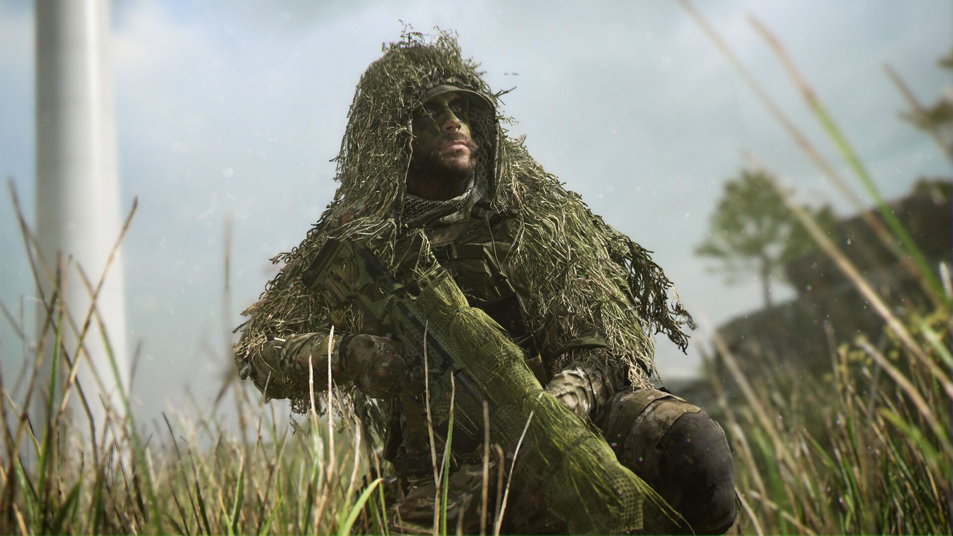 Video game screenshot of a solider on one knee in tall grass