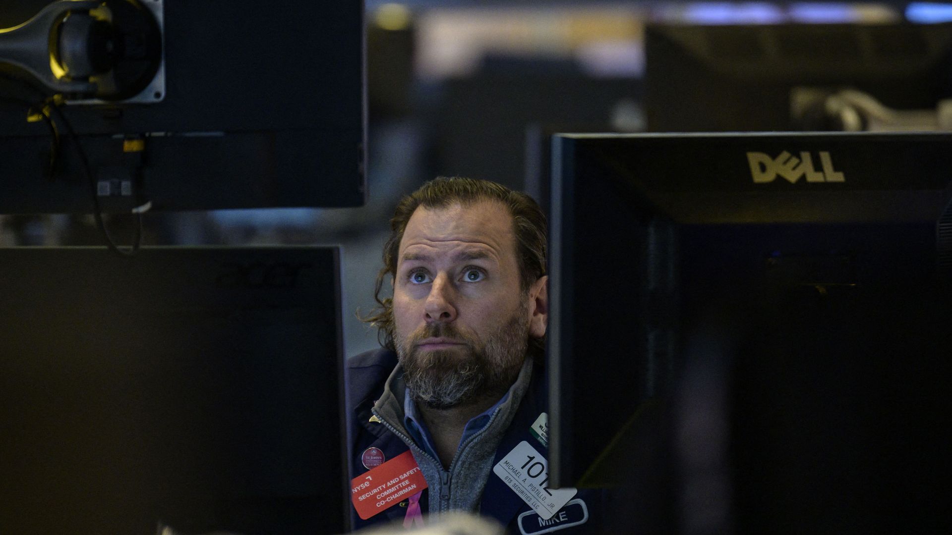Man looks at screens at New York Stock Exchange