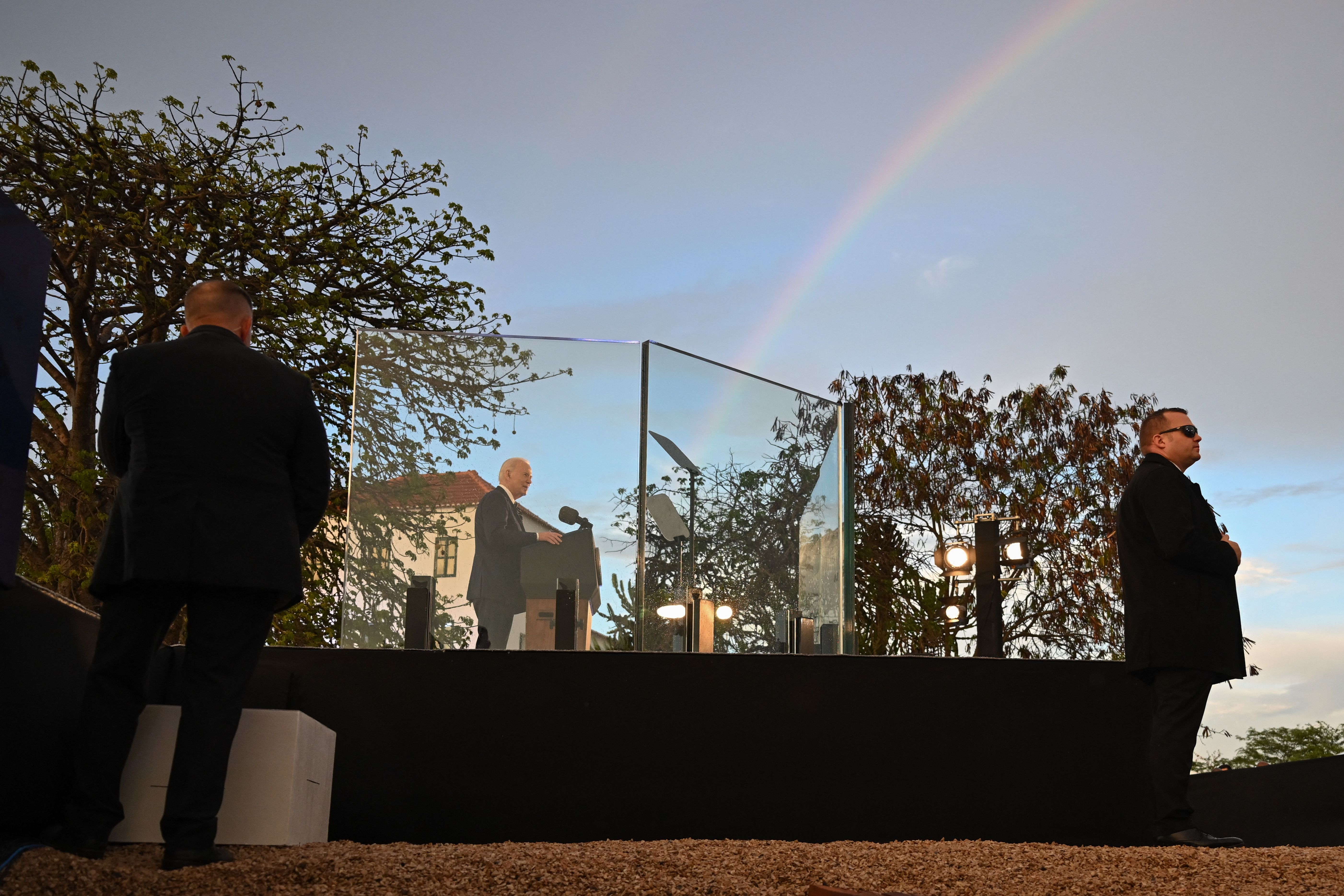 A general view of a rainbow in the sky as US President Joe Biden speaks during his visit to the National Slavery Museum in Morro da Cruz, near Luanda, on December 3, 2024. (Photo by ANDREW CABALLERO-REYNOLDS / AFP) (Photo by ANDREW CABALLERO-REYNOLDS/AFP via Getty Images)