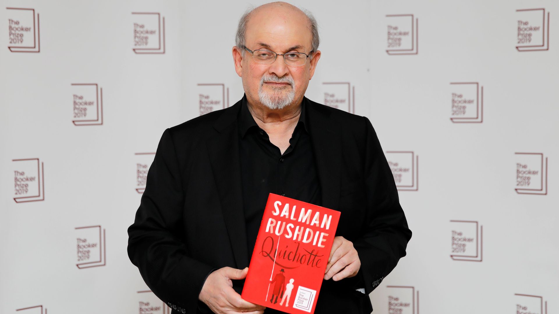 Author Salman Rushdie posing with a book in London in October 2019.