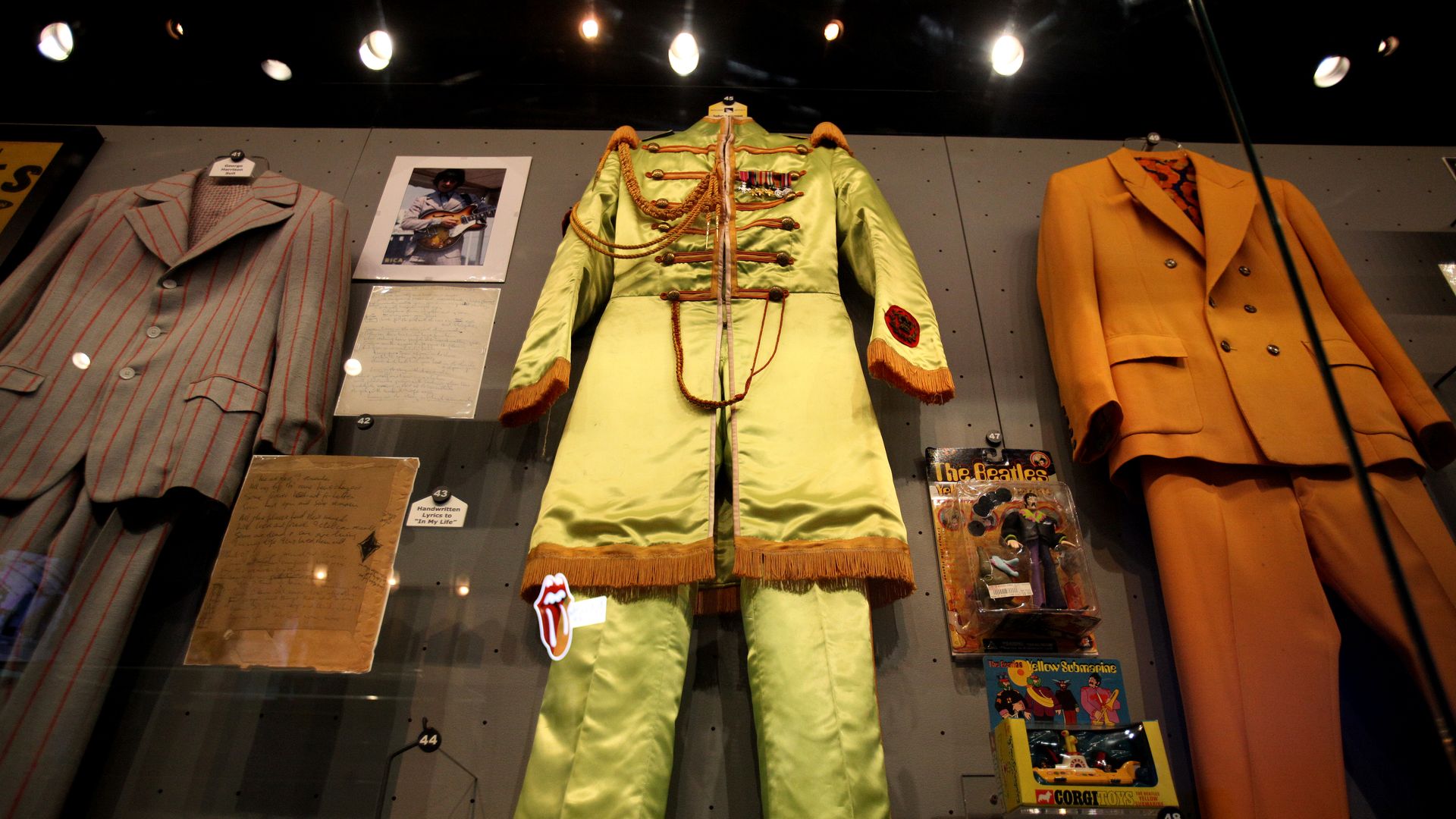 John Lennon's lime green "Sgt. Pepper's Lonely Hearts Club Band" costume inside a glass case.