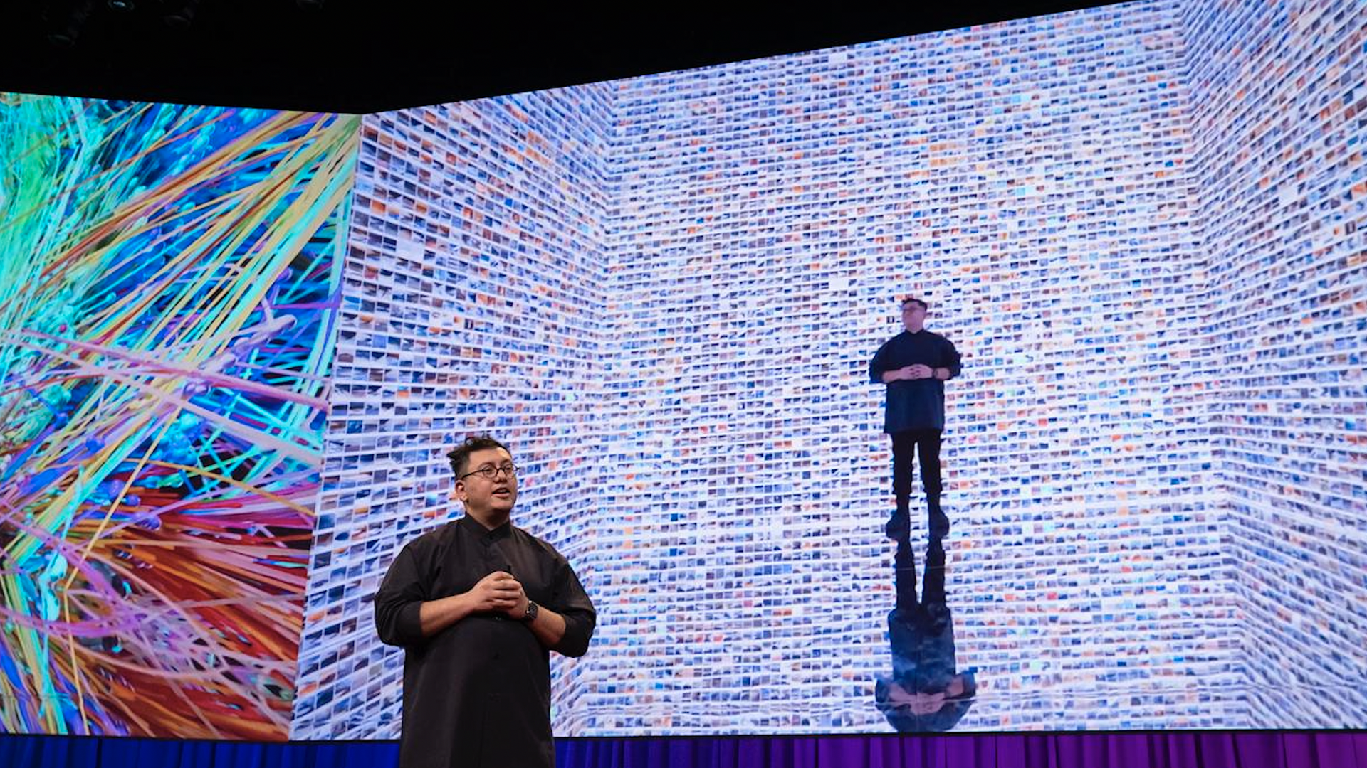 Refik Anadol, speaking  at TED2023 in front of an array of photos