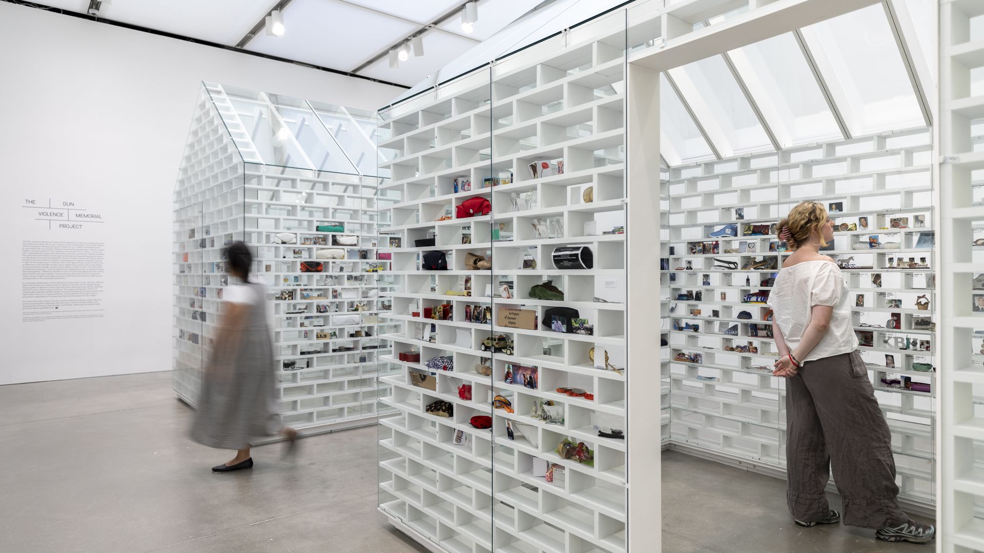 Glass brick homes in an art exhibition contain small mementos in about half of the bricks.