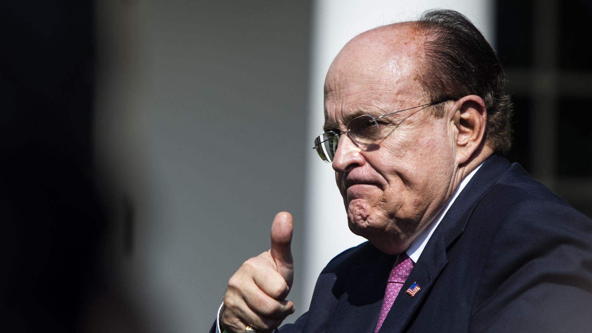 In this image, Rudy is making a thumbs up at the camera.