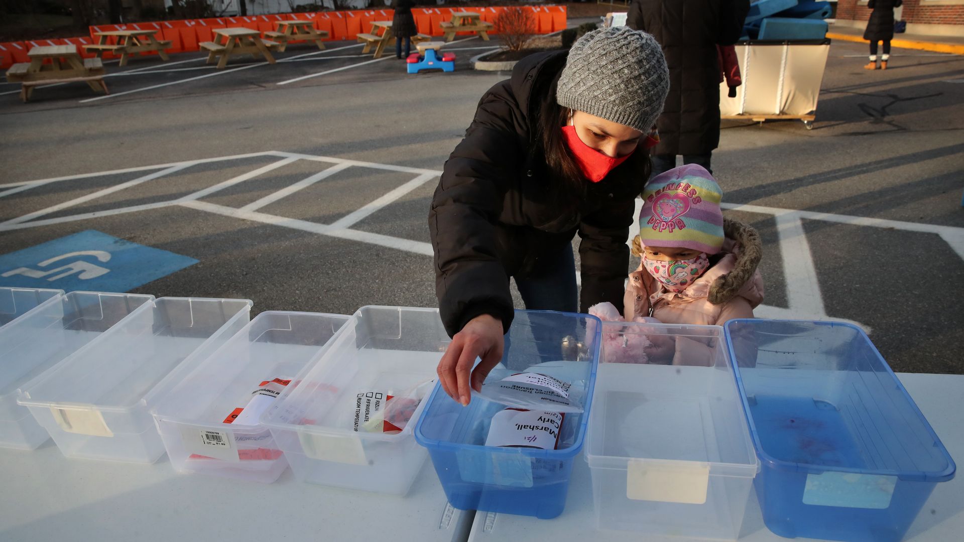 A Preschool drops off a specimen after helping her daughter collect a sample