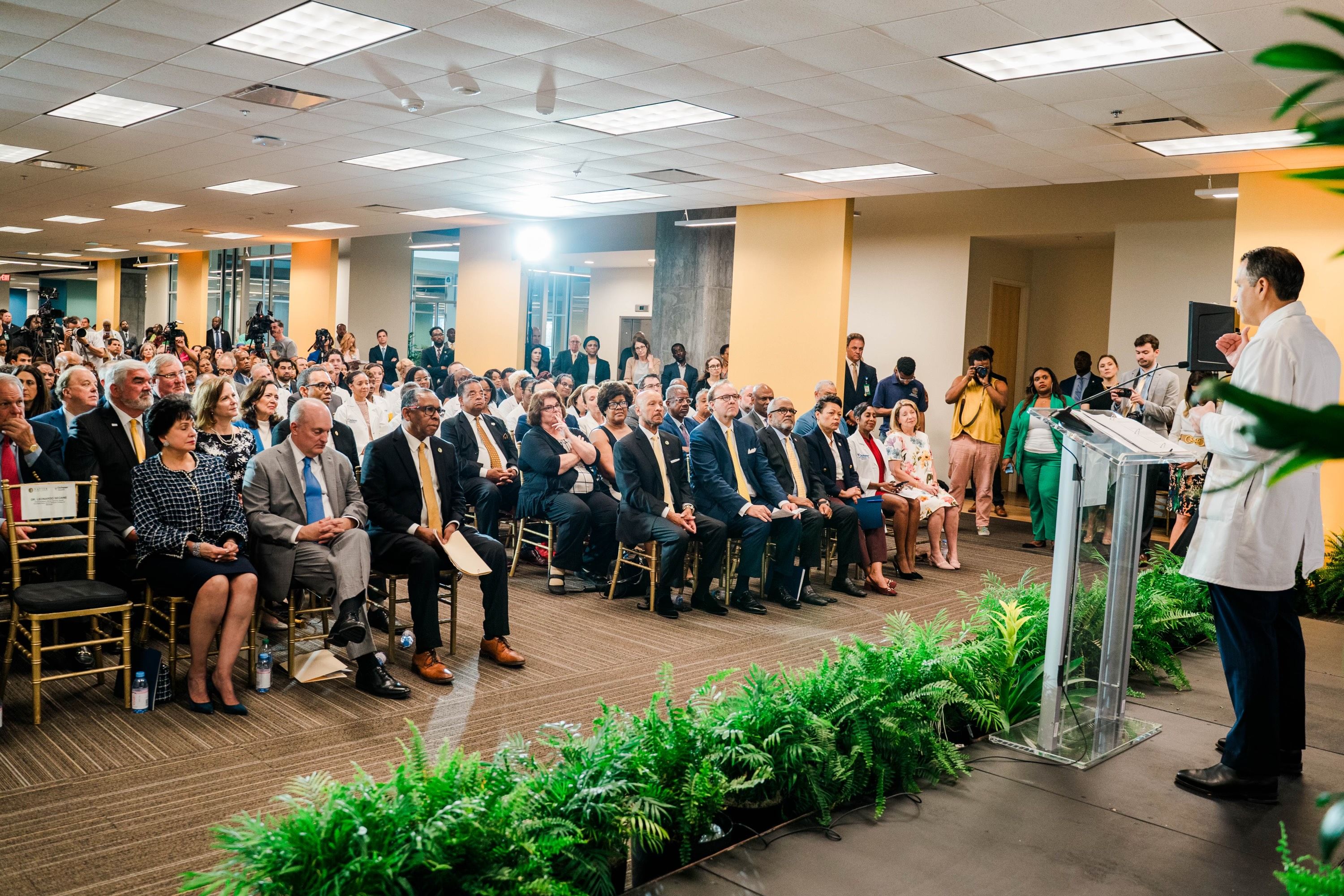 Photo shows a man talking to a crowd.