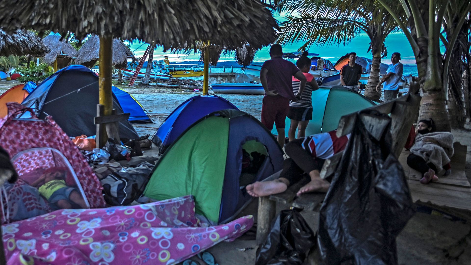Migrants crossing from Colombia to Panama wait in encampments. 