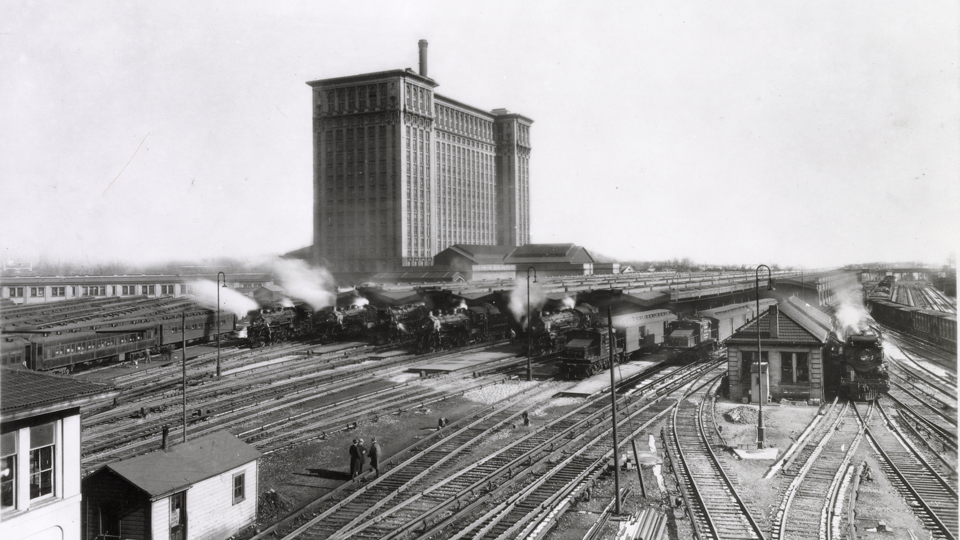 A black and white photo of the train station showing many rail lines.