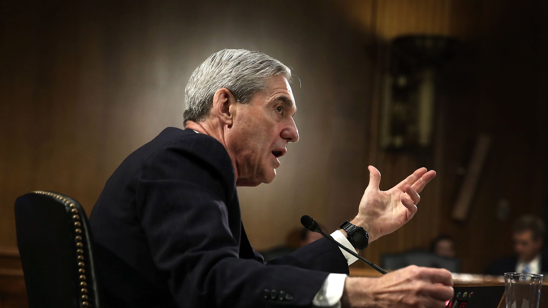 Robert Mueller sits at a table.