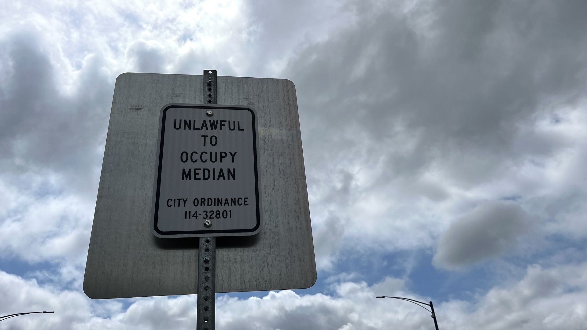 "Unlawful to occupy median"