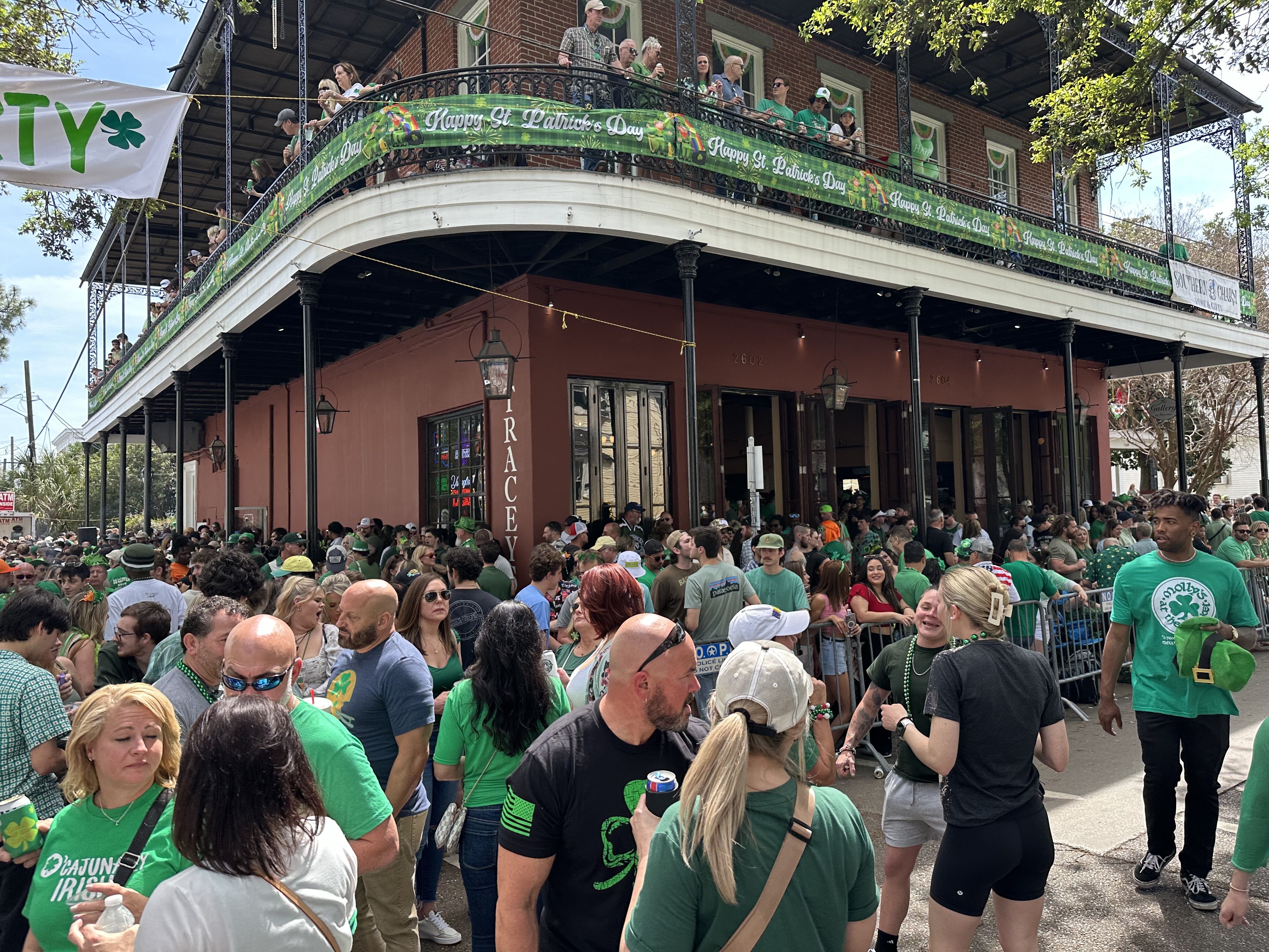 A St. Patrick's Day crowd gathers outside a corner bar.