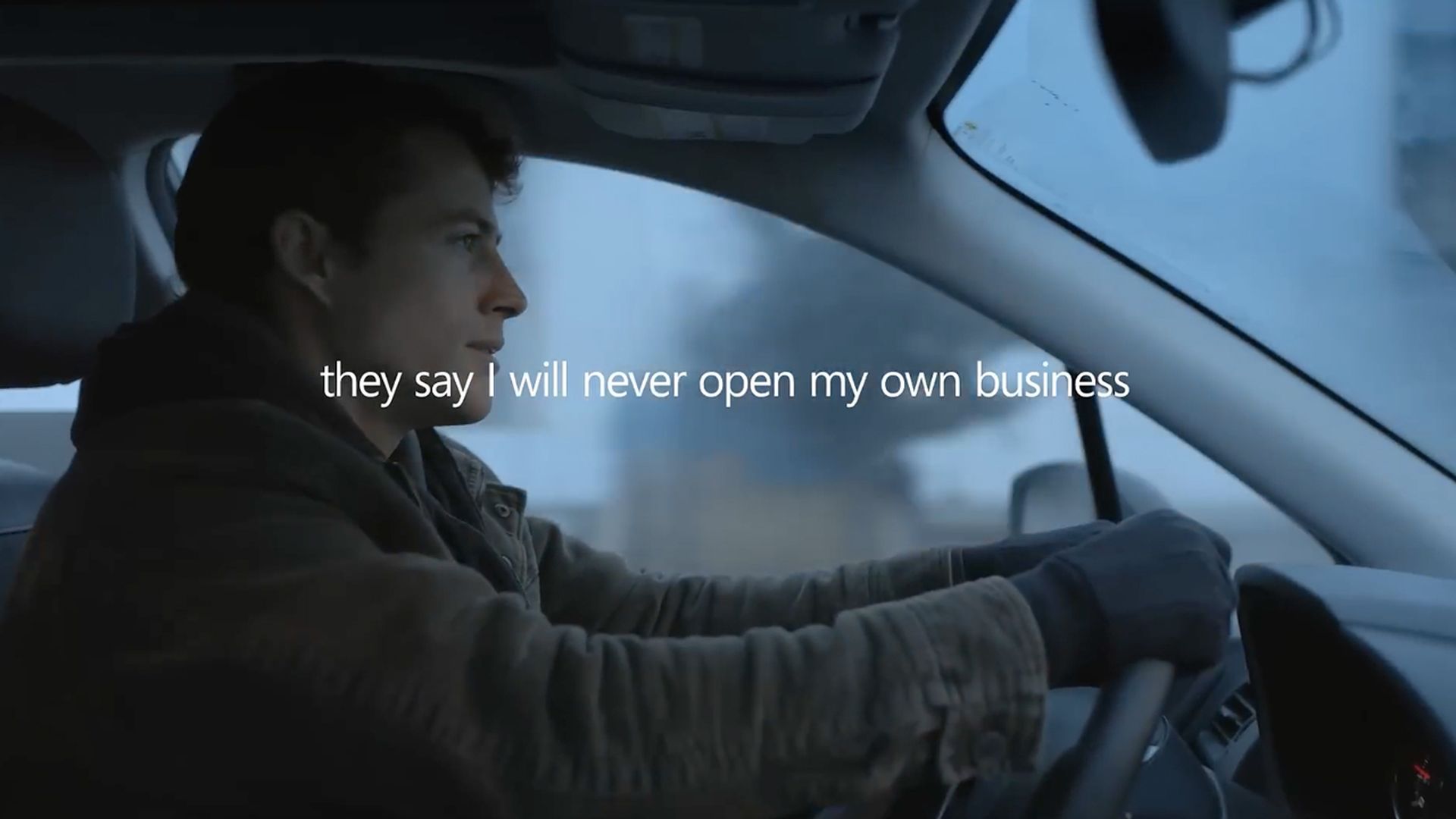 Screen capture from Microsoft Copilot ad showing a man at a car's steering wheel with the words "They say I will never open my own business" overlaid