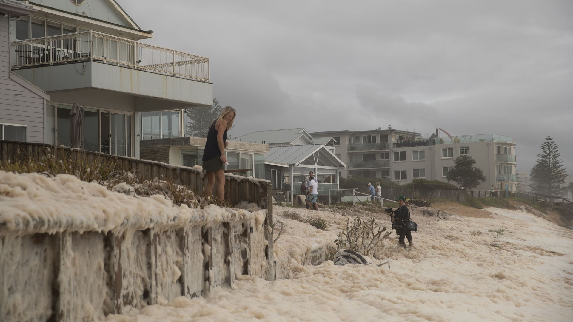 A resident watches on at Collaroy on the Northern Beaches as a high tide and large waves impact the coast on February 10, 2020 in Sydney,