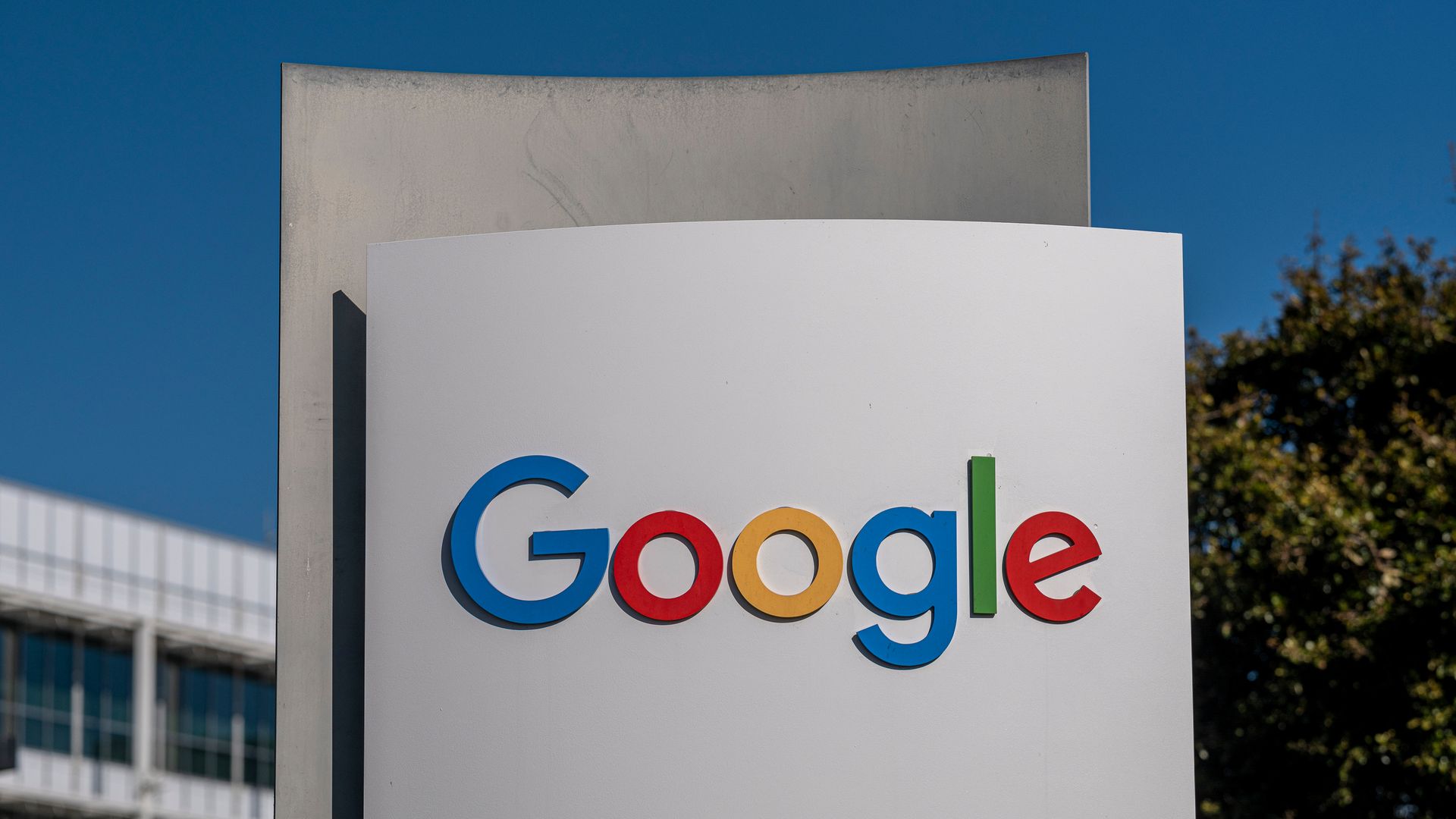 Google sign in front of Mountain View campus against blue sky