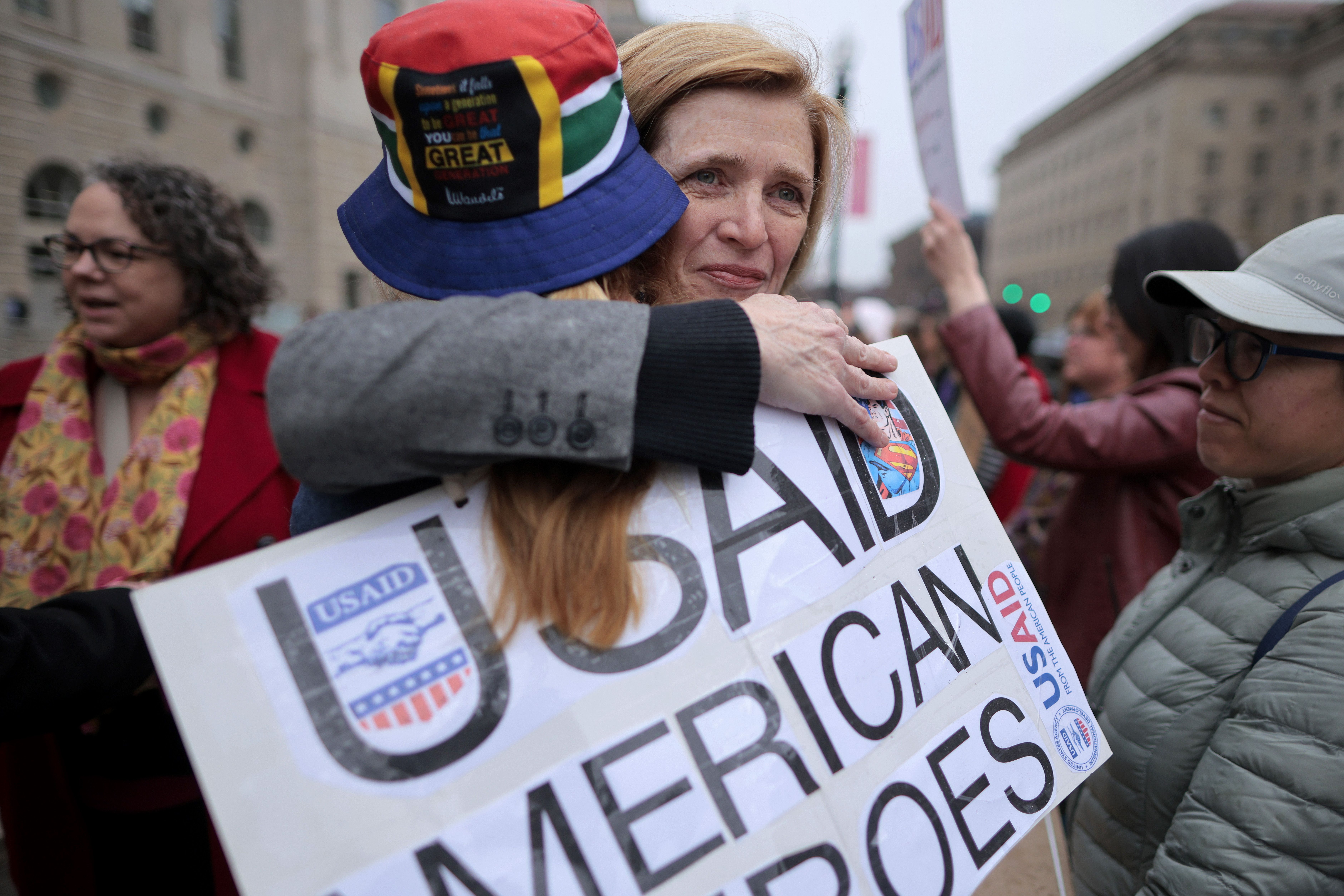 Ambassador Samantha Power (C), former head of the United States Agency for International Development (USAID), embraces fired employees and their supporters outside the agency's headquarters as former workers came to collect their personal belongings on February 27, 2025 in Washington, DC. Thousands 