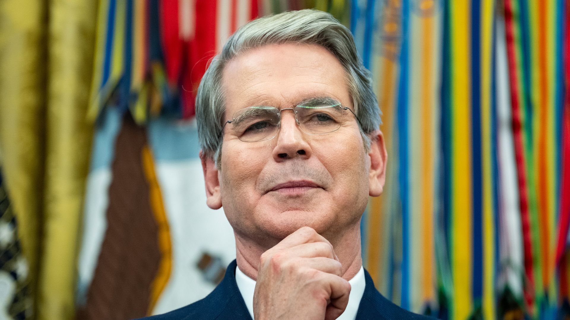 Scott Bessent holds his hand to his chin during an Oval Office event.