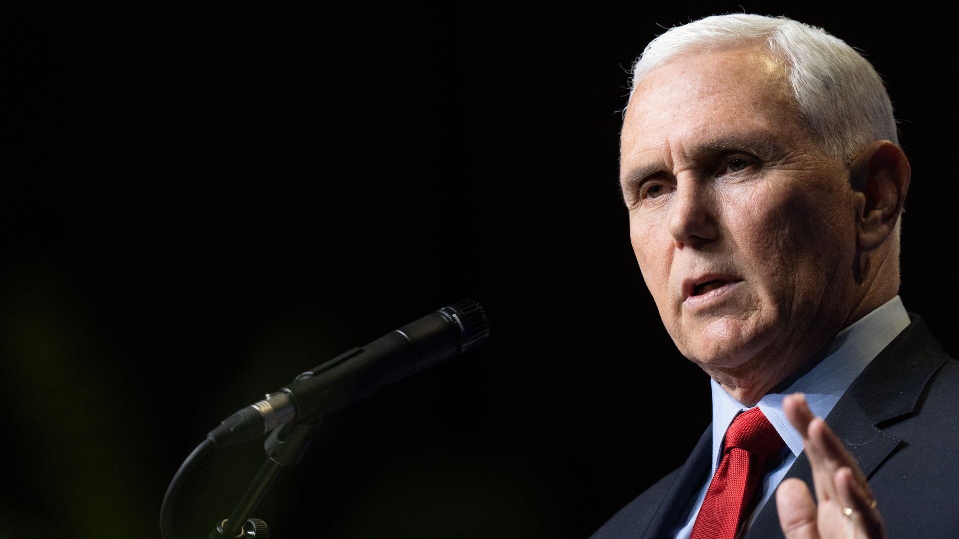 Photo of Mike Pence speaking with one arm raised