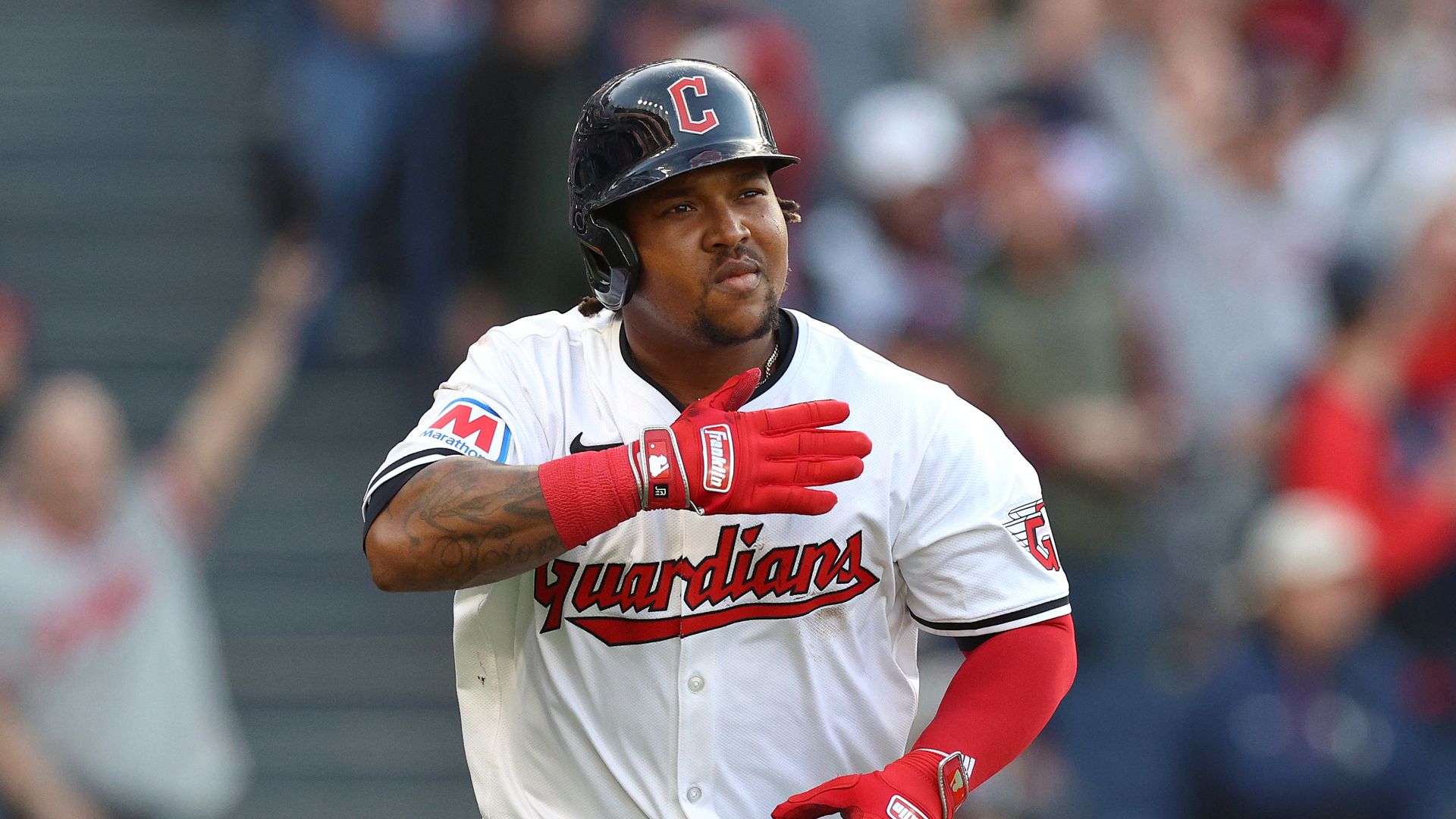 Guardians player Jose Ramirez pats himself on the chest as he rounds the bases.