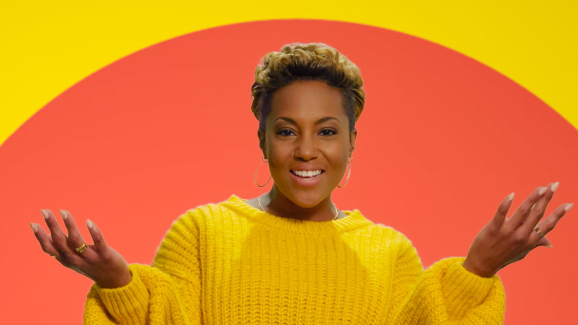 A woman facing the camera with her arms out