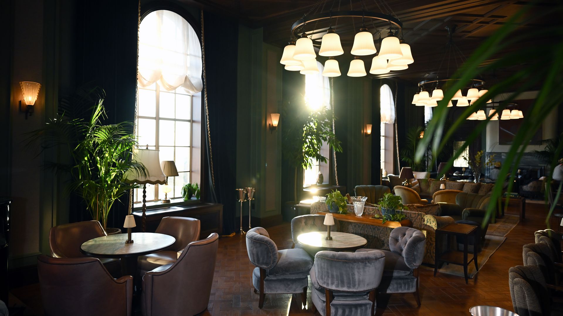 A photo showing a dining area inside a private club, with tables and chairs.
