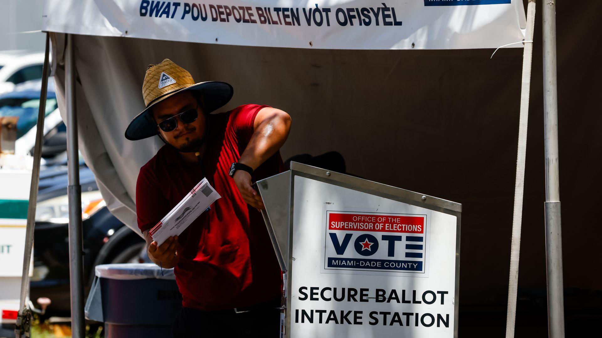 An election worker drops off ballots in a secure ballot intake station at the Miami-Dade County Supervisor of Elections Office during a primary election in Doral, Florida, US, on Tuesday, Aug. 18, 2026. The gubernatorial campaign is unfolding at a time when many Floridians are watching the cost of l