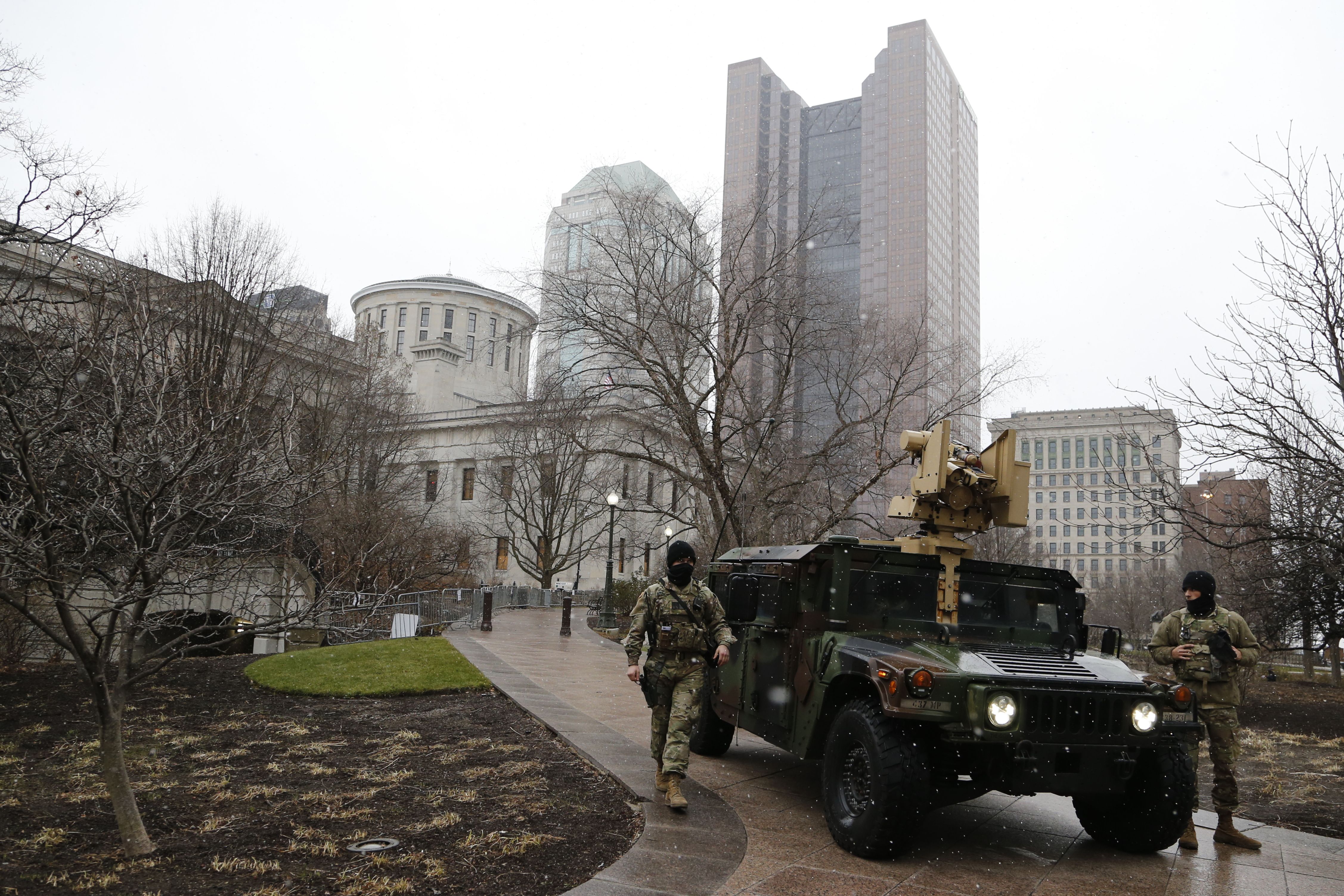 Ohio National Guard members are seen patrolling an area outside the Statehouse. 
