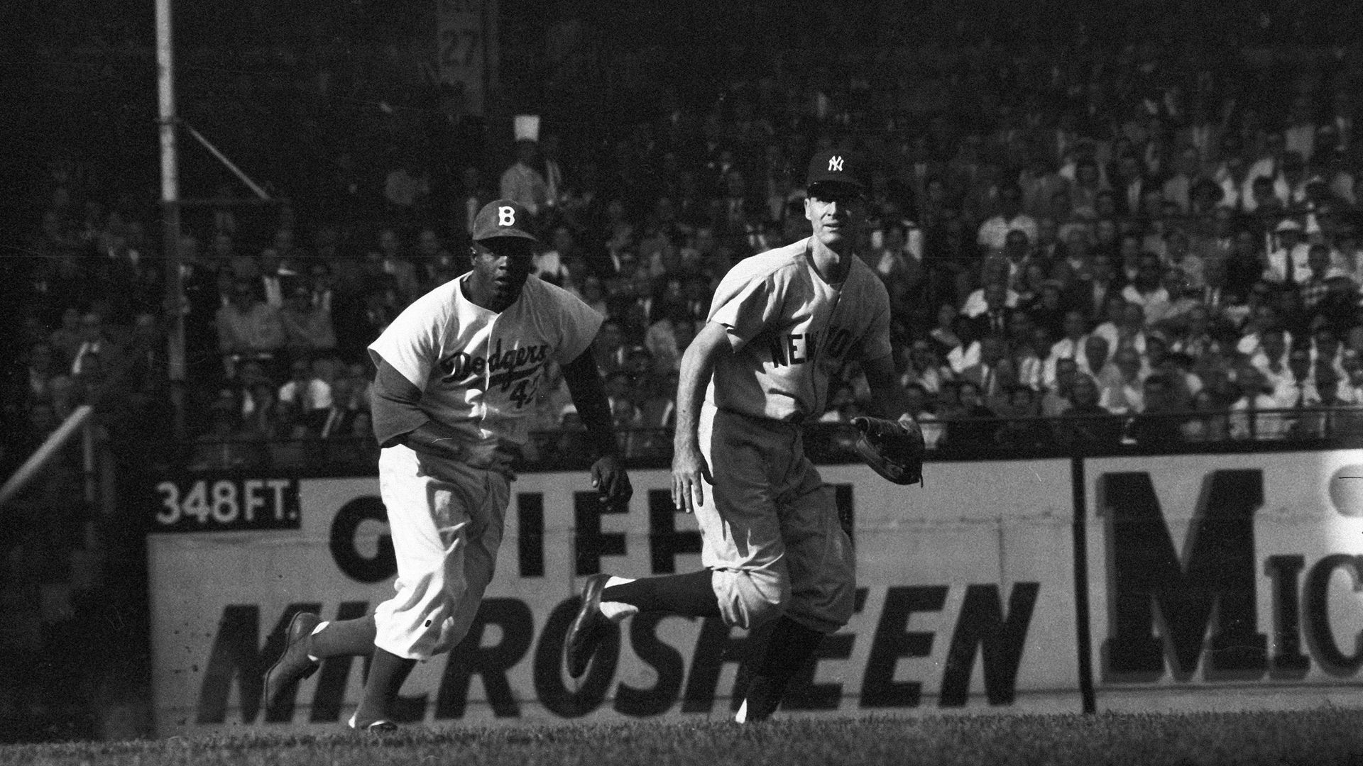 New York Yankees Jerry Coleman (42) in action, attempting to pick-off Brooklyn Dodgers Jackie Robinson (42) in game five of the 1955 World Series at Ebbets Field in Brooklyn, New York.