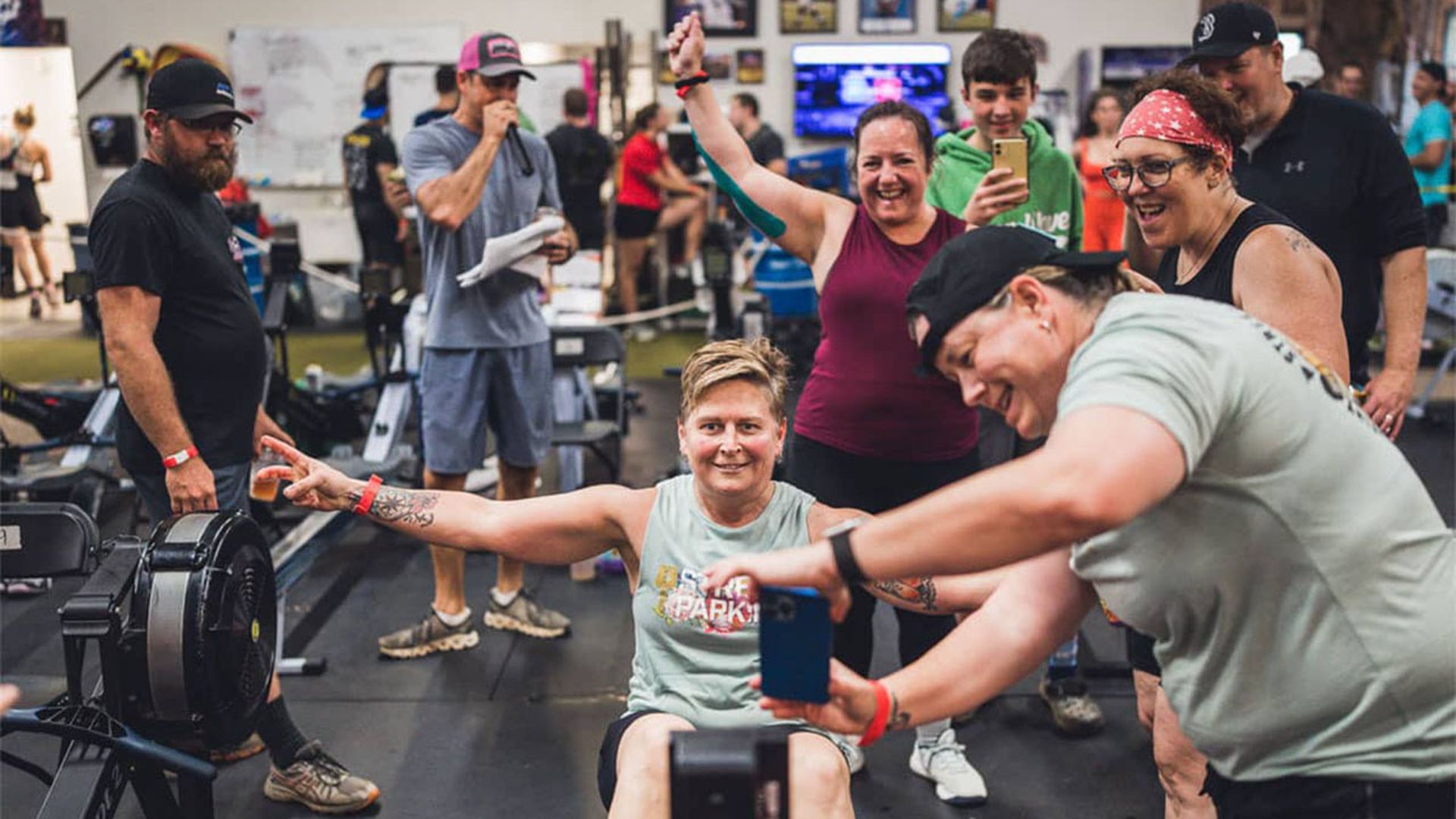 People celebrate accomplishing a rowing challenge. 
