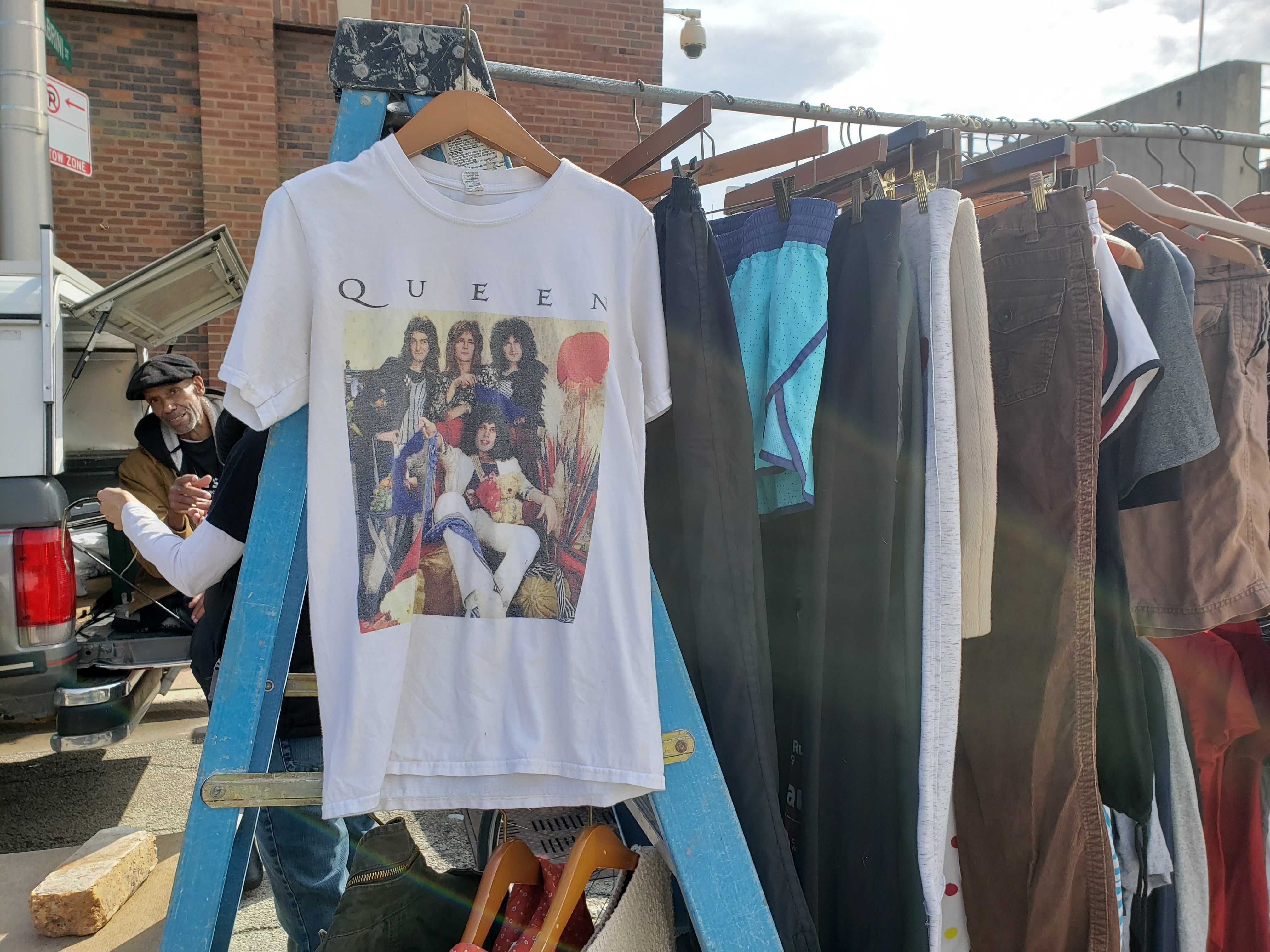 Photo of an old t-shirt hanging on a rack.