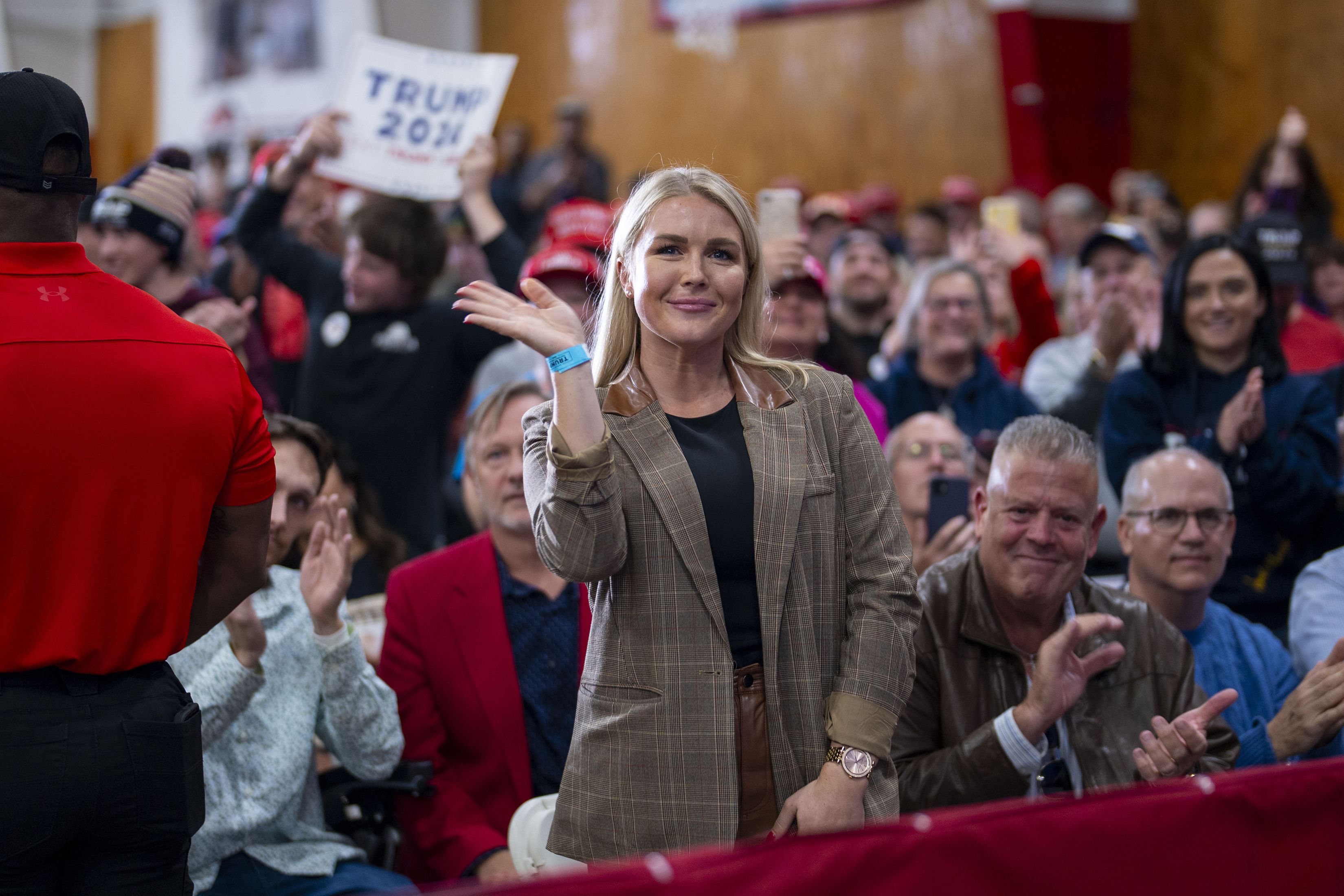 Karoline Leavitt smiles and waves amid a crowd of supporters