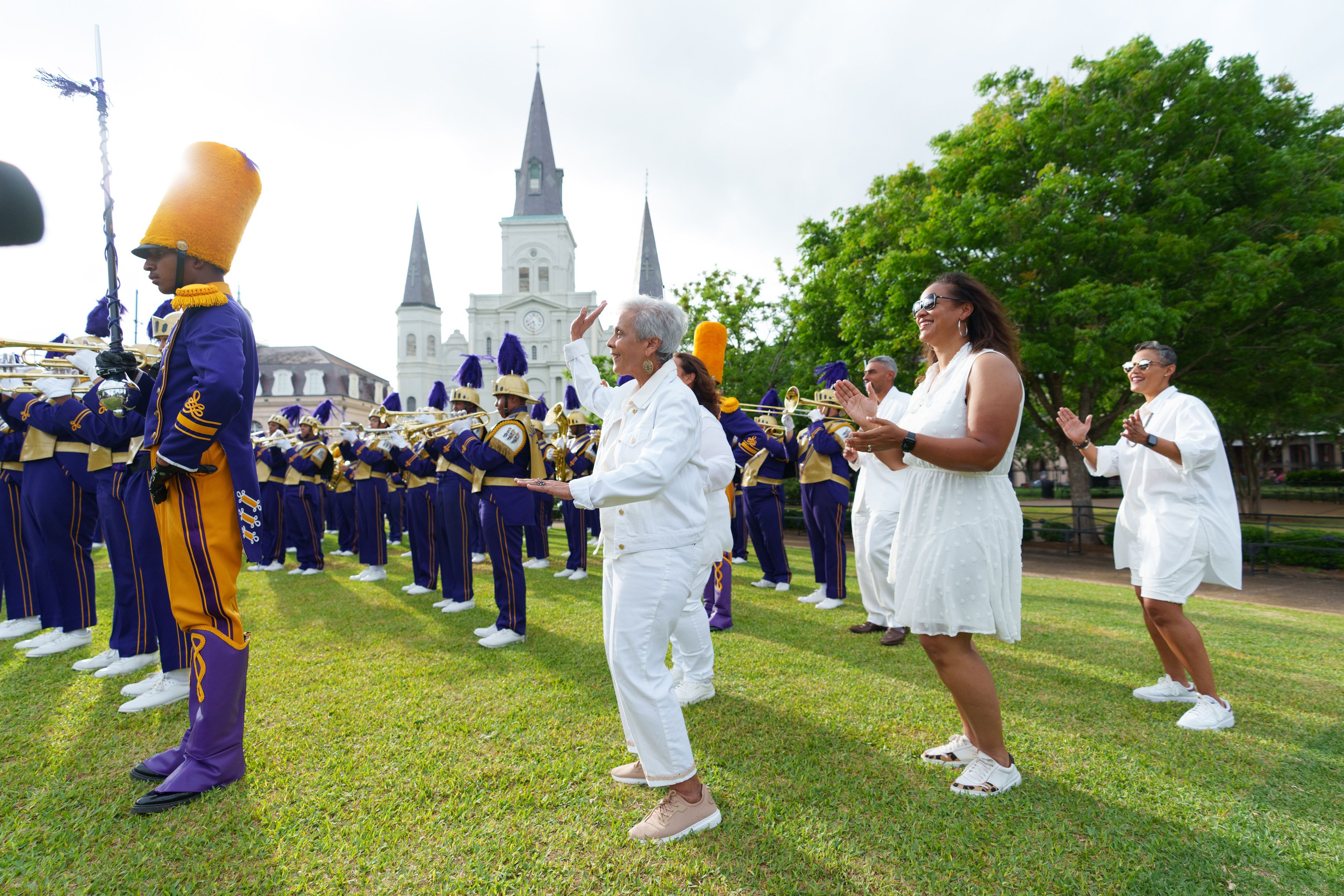 Photo shows the Chase family in Jackson Square with the St. Aug Marching 100.
