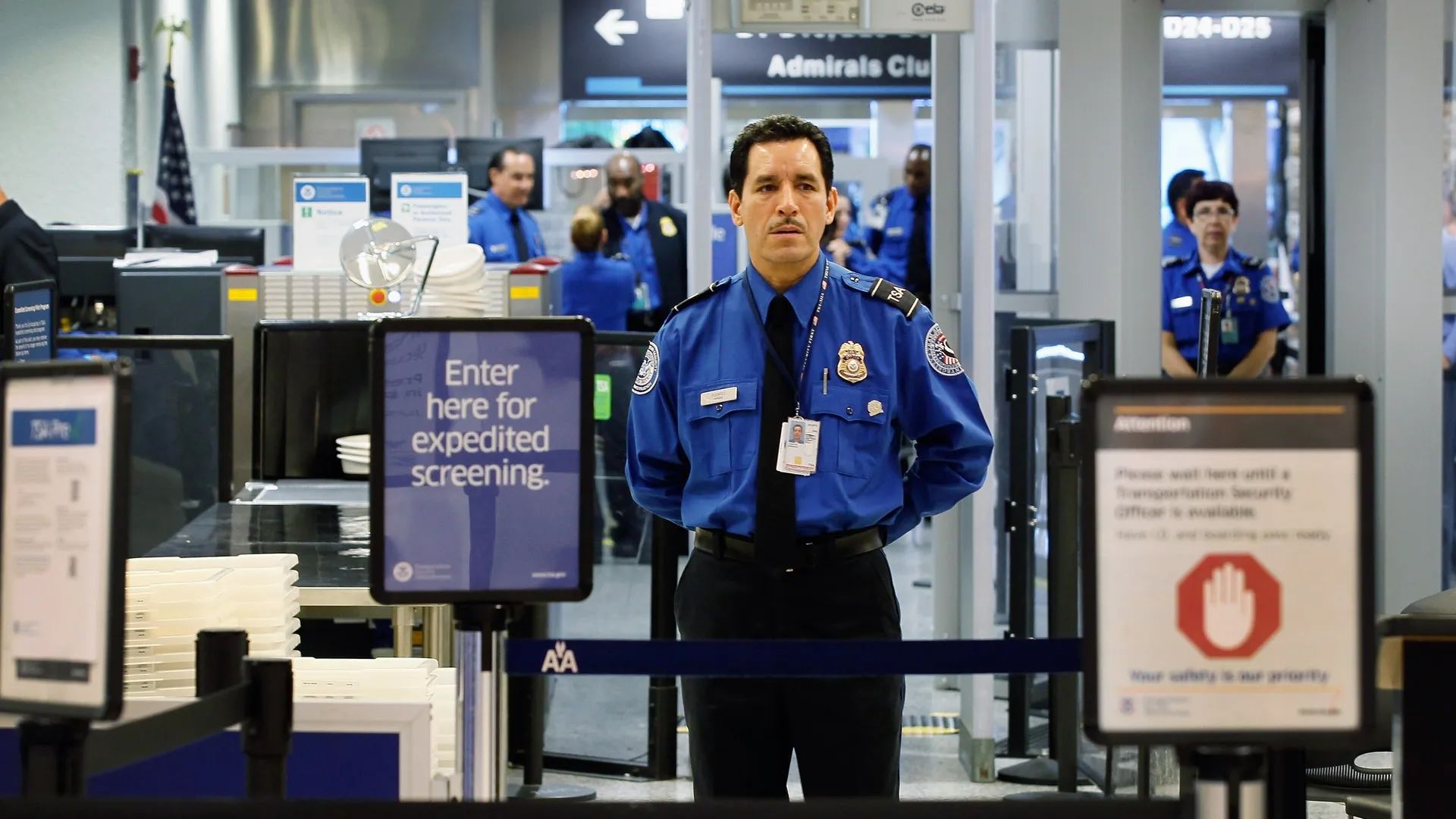 A TSA agent at the security area in an airport.