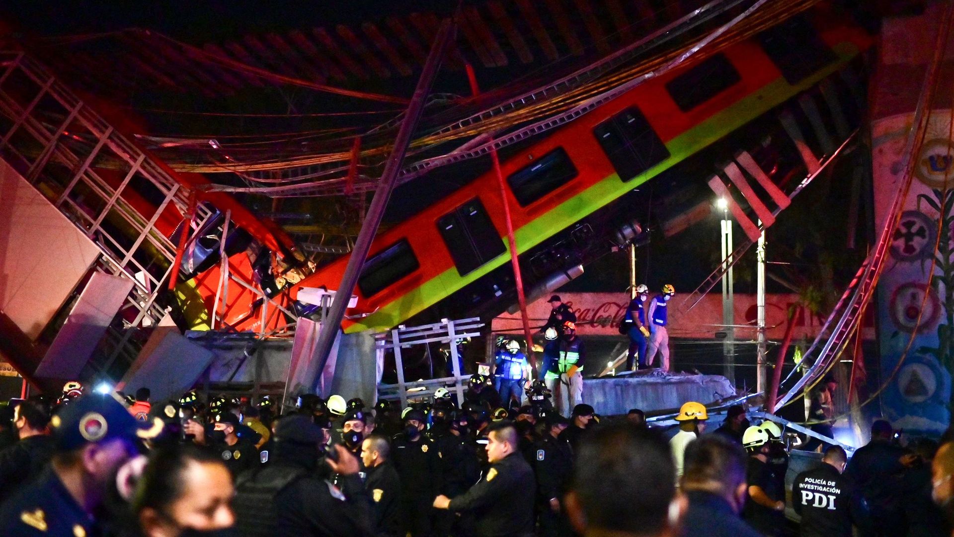 Rescue workers gather at the site of a metro train accident after an overpass for a metro partially collapsed in Mexico City on May 3, 2021.