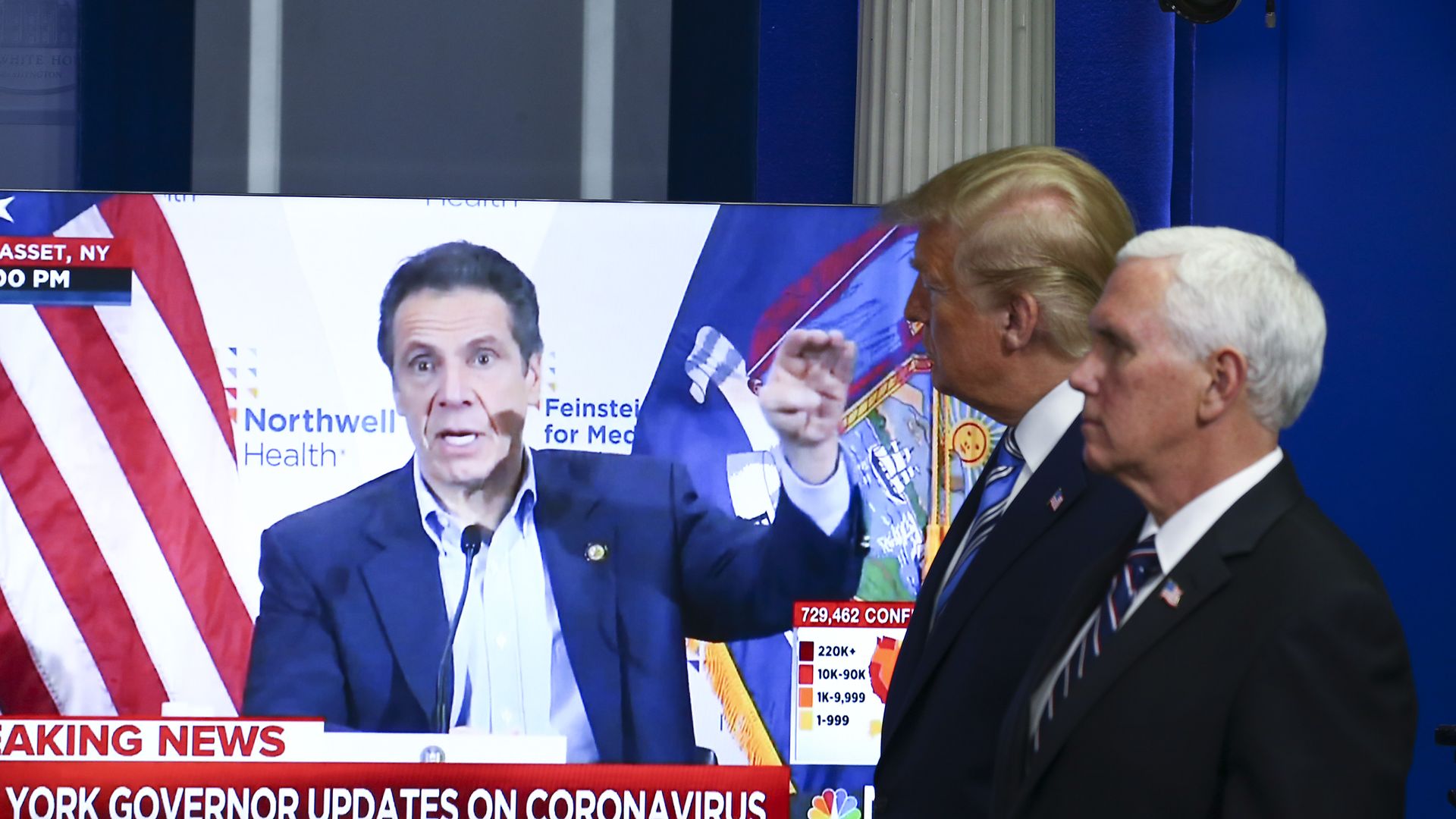 President Trump and Vice President Mike Pence are seen walking by a TV showing a COVID-19 press briefing by New York Gov. Andrew Cuomo.