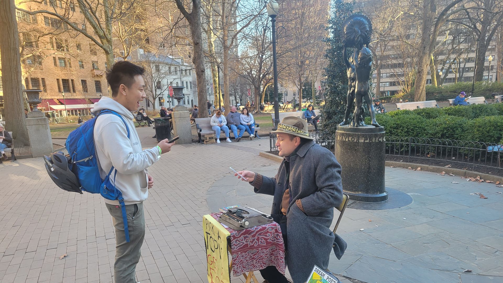 Street poet Marshall James Marshall, right, chats with UPenn student Jerry Cai at Rittenhouse Square.