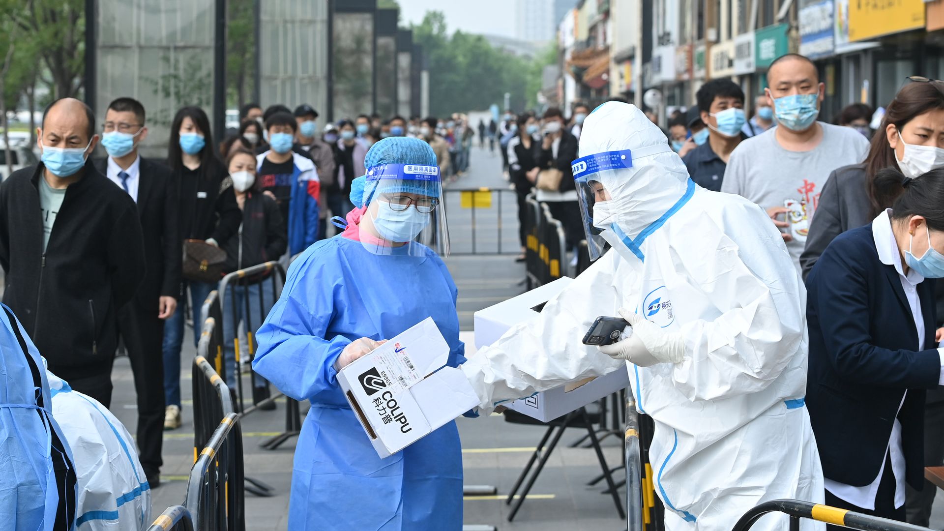 People queue up at a COVID-19 nucleic acid testing site of Chaoyang district in Beijing, China.